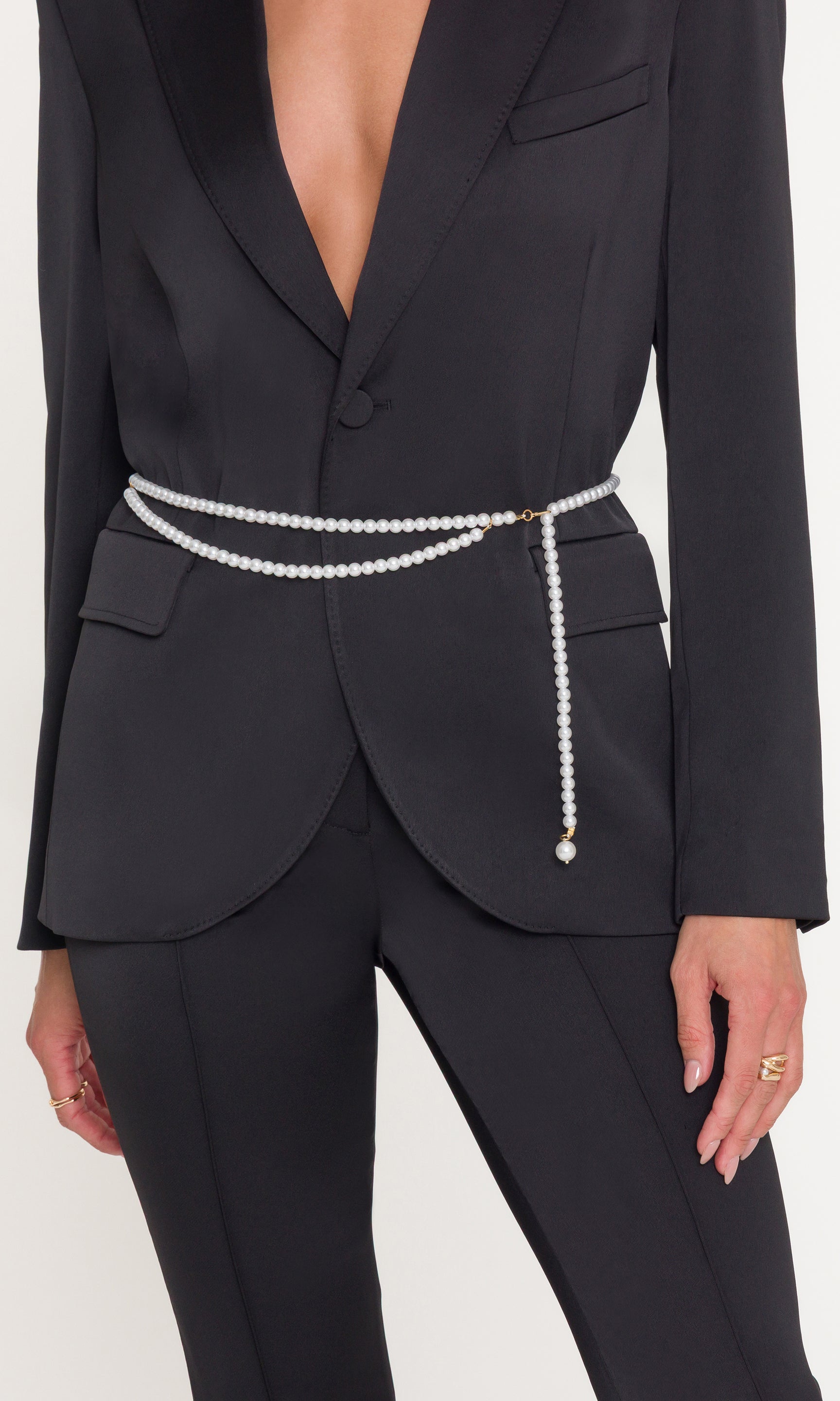 Black suit with pearl belt on a white background