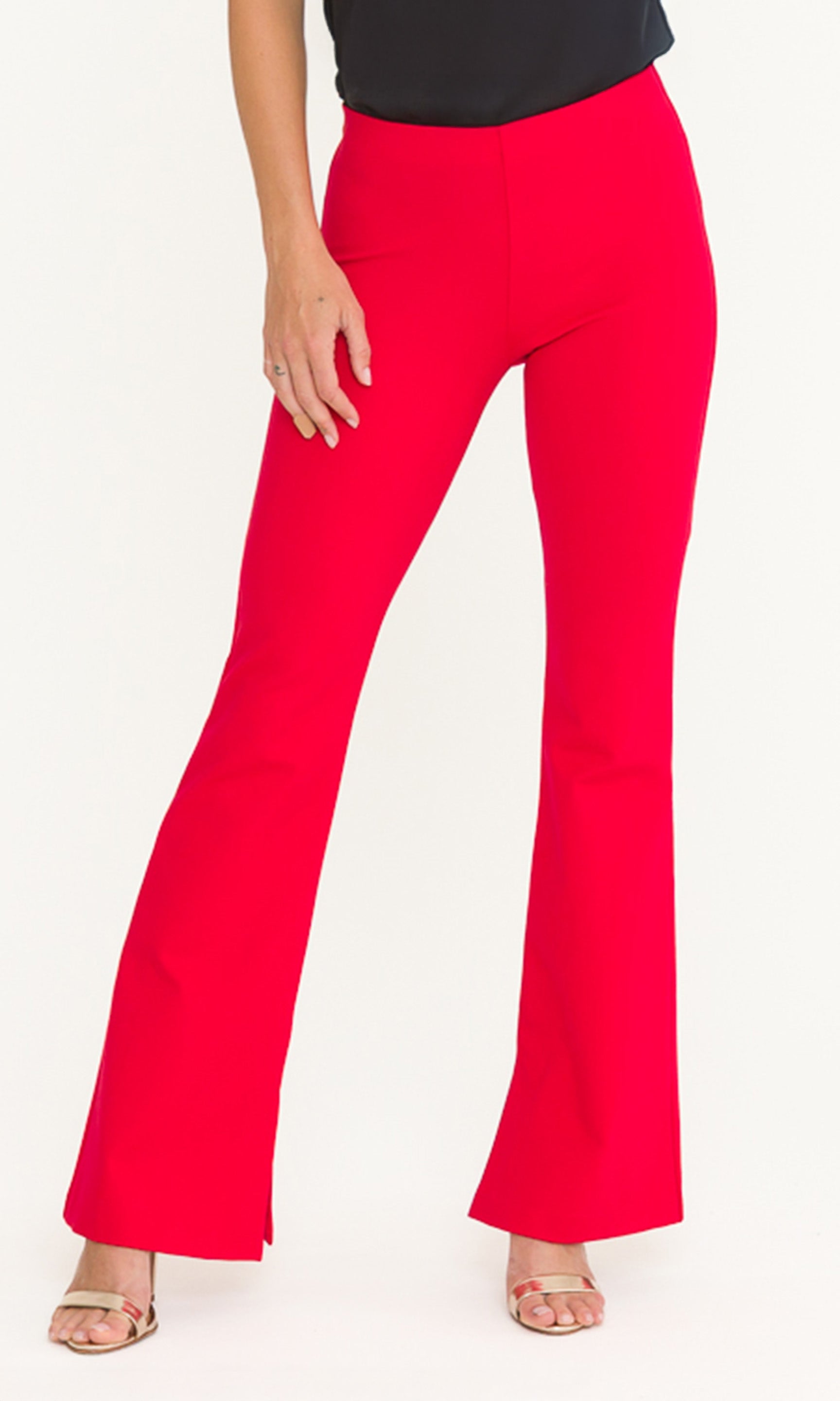 Front crop image of red flared pants worn by a person on a white background