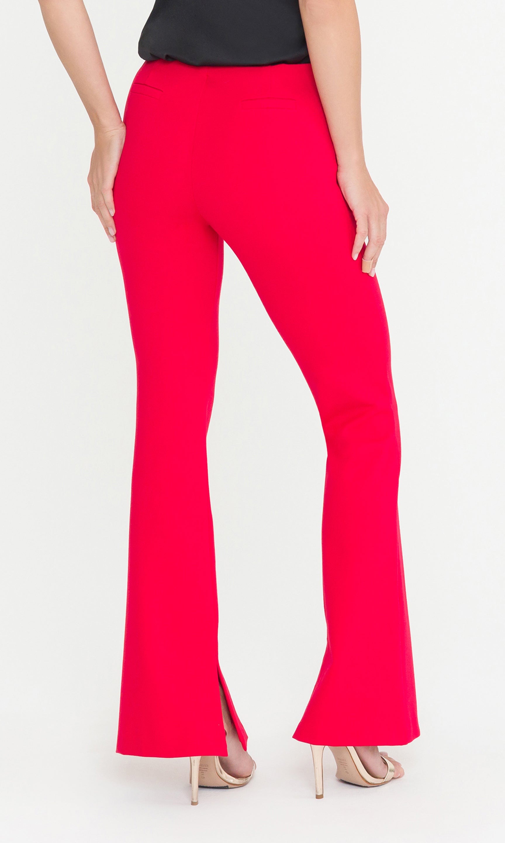 Back crop image of red flared pants worn by a person on a white background