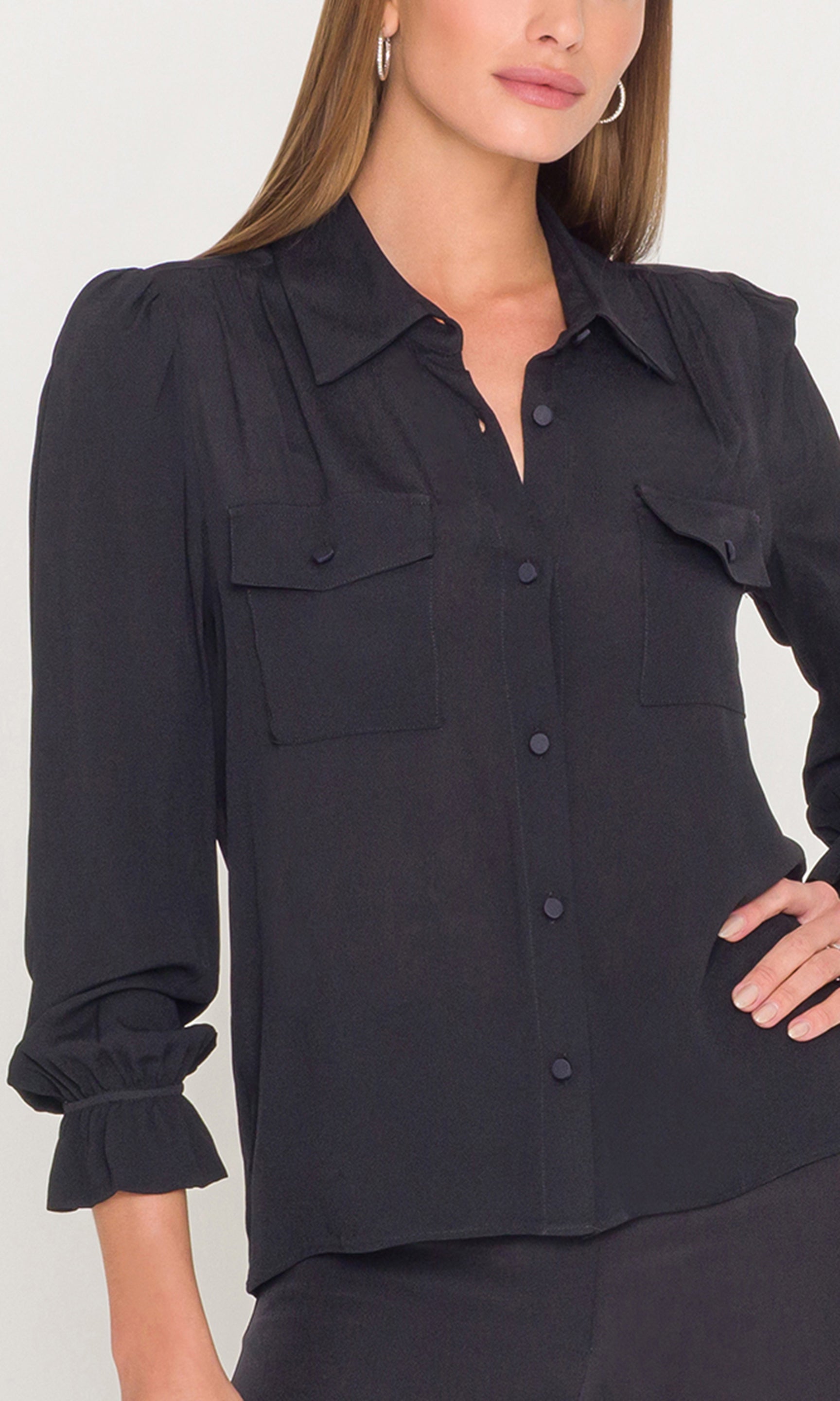 Black button-up shirt worn by a person on a white background