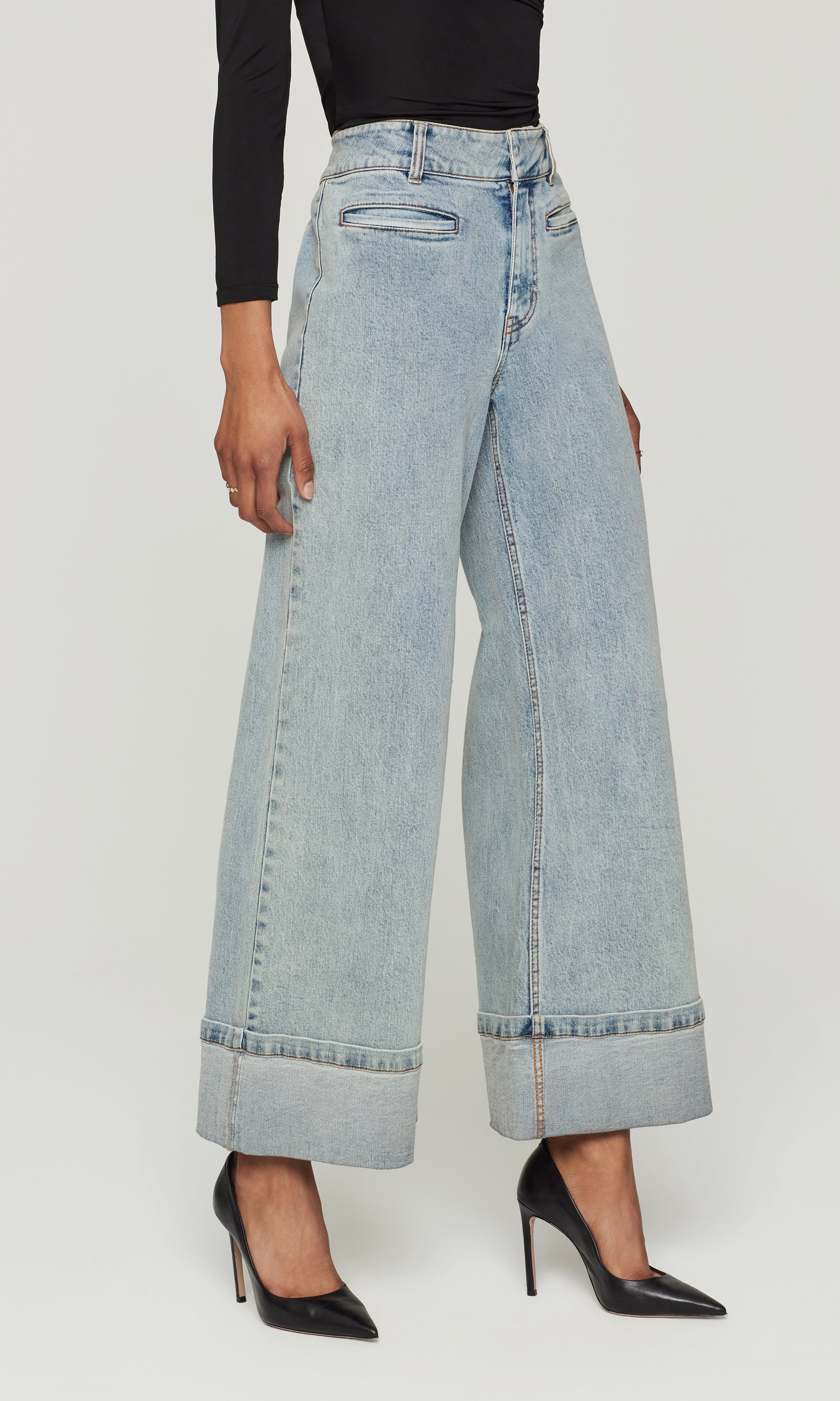 Side view of light blue wide-leg jeans worn by a person on a white background