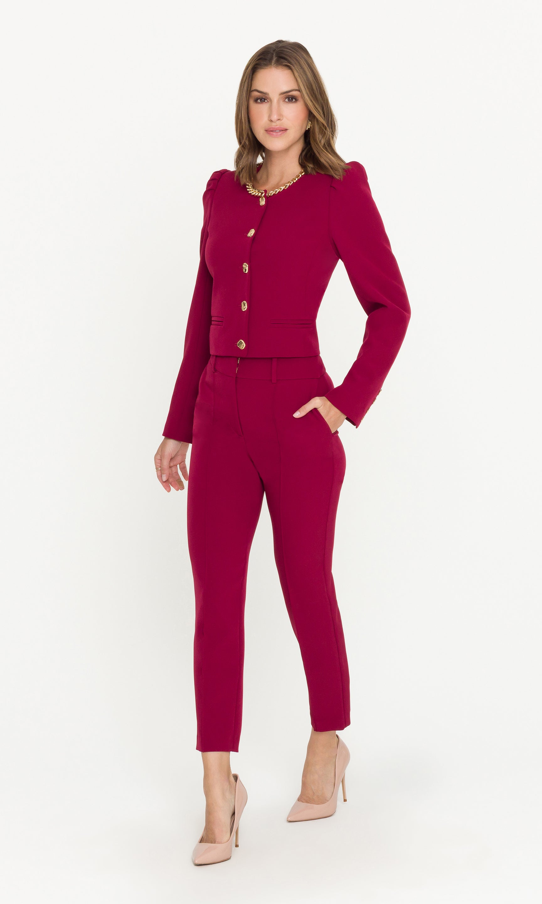 Woman wearing a red suit with a white background