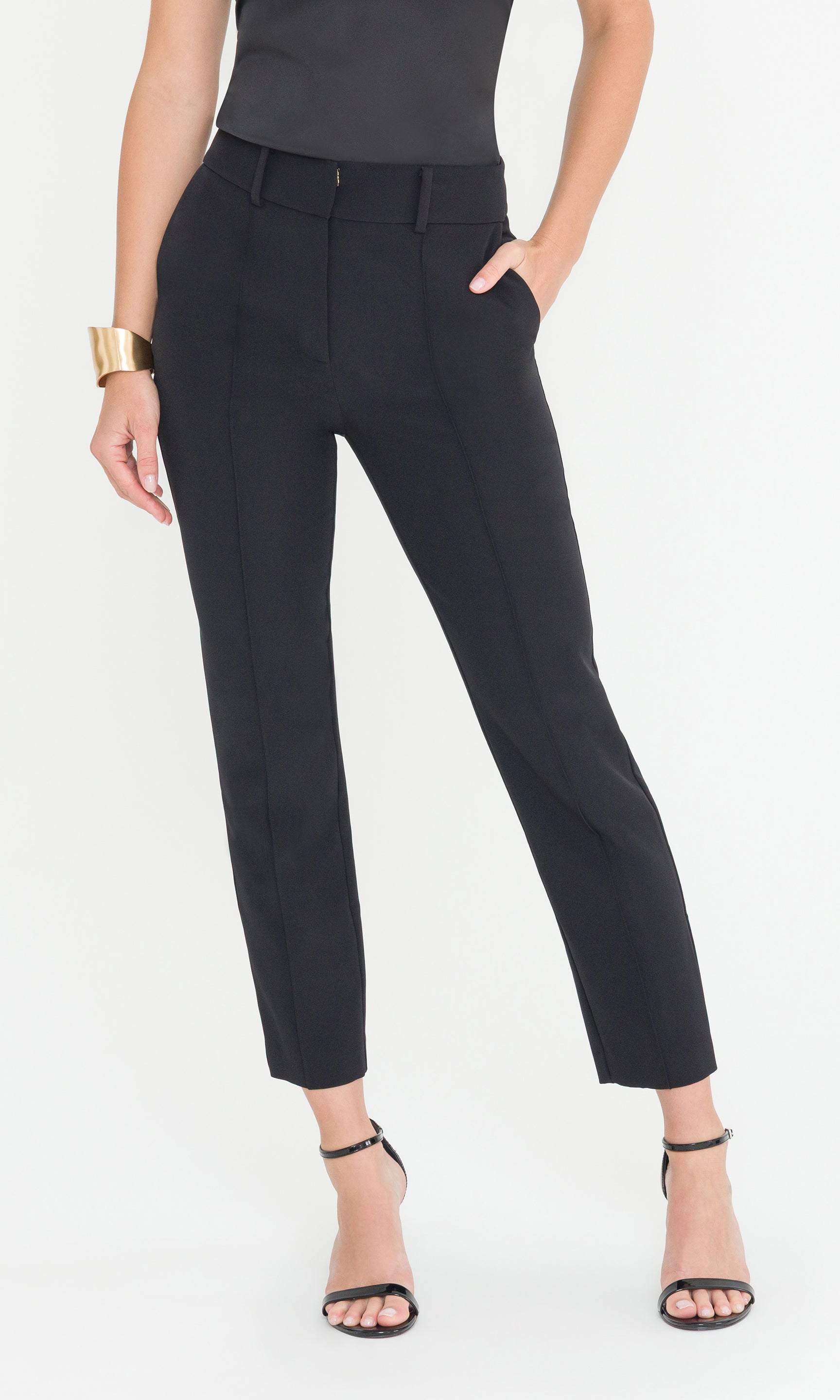 Black pants worn by a person on a white background