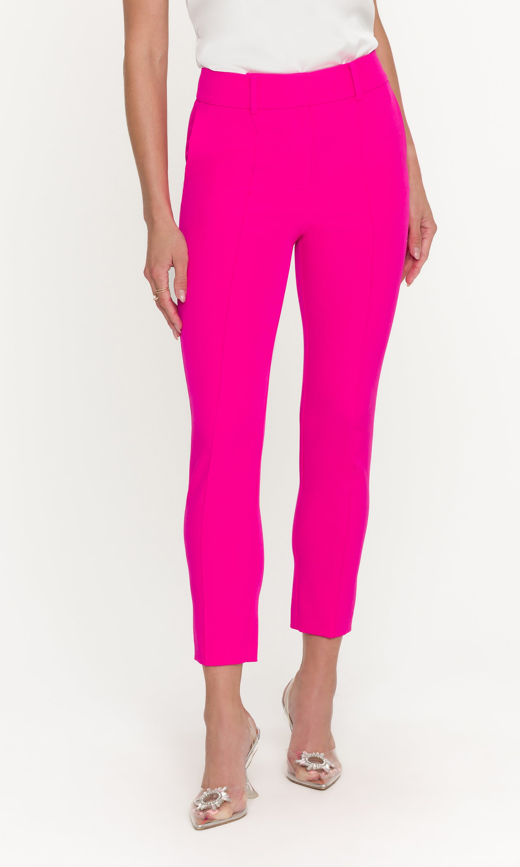 Person wearing bright pink pants on a white background