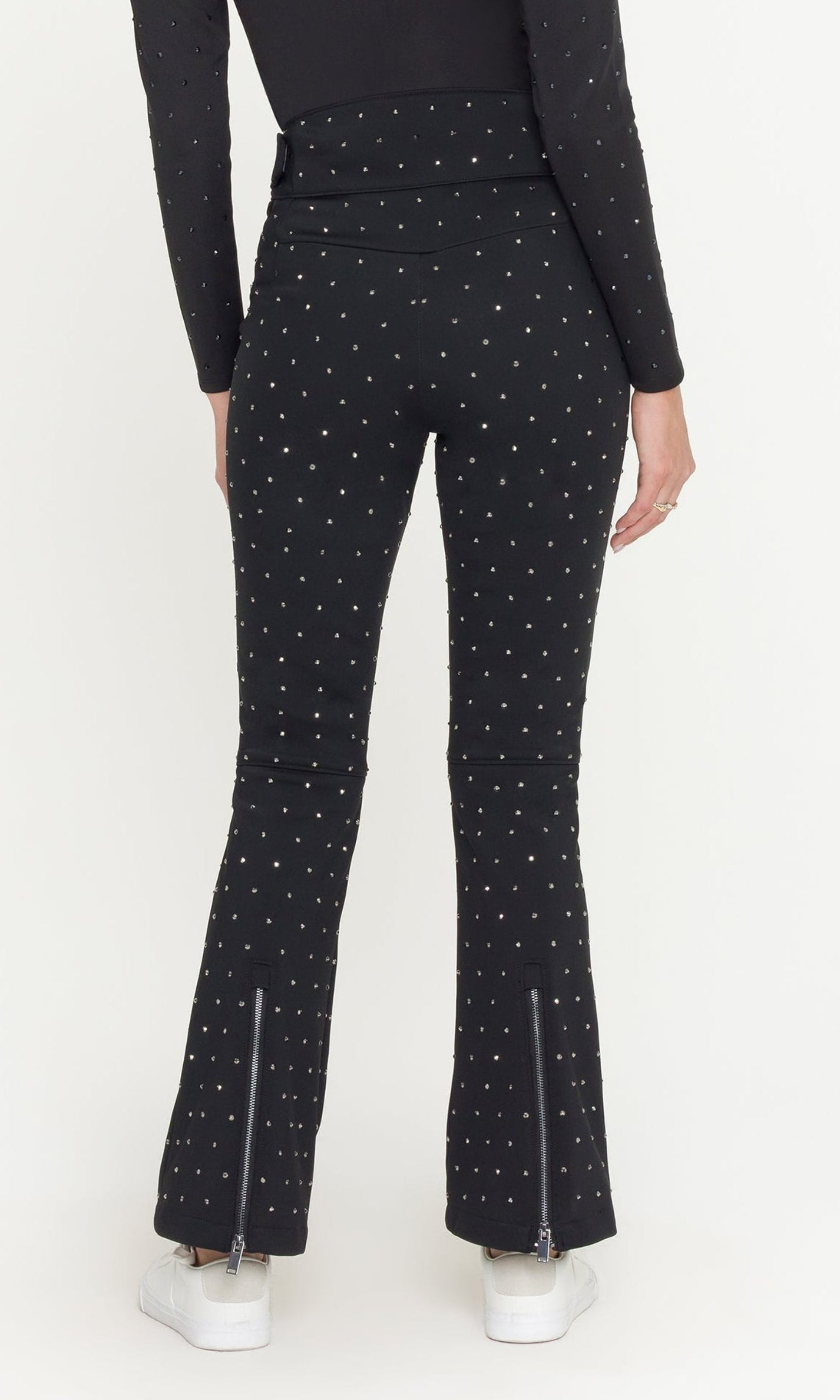 Woman wearing a black outfit with a patterned design on a white background