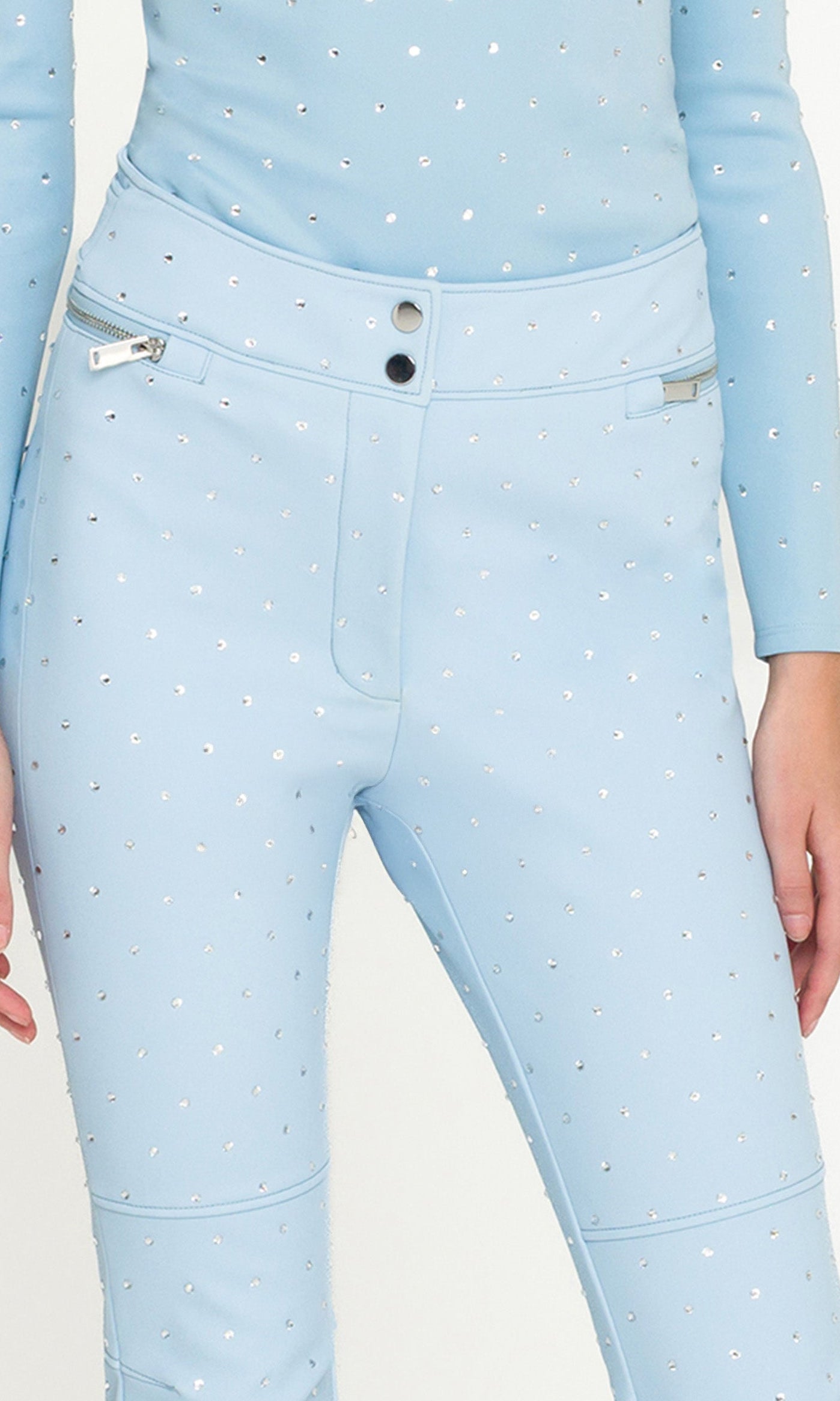 Light blue crystal embellished pants with a matching top on a white background