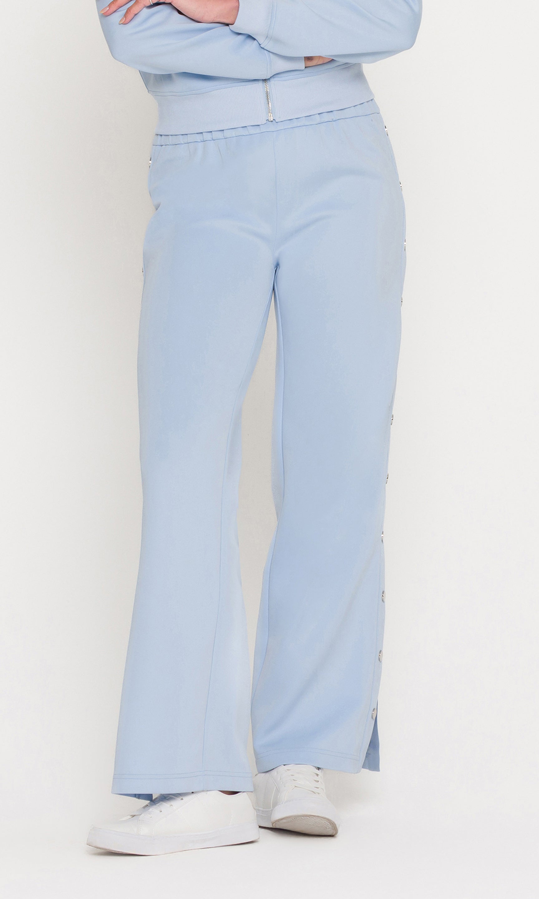 Light blue pants worn by a person on a white background