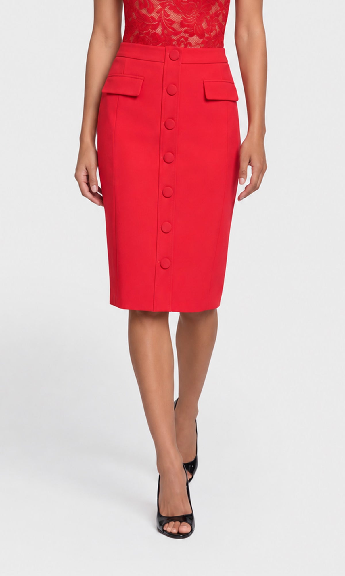 A model wearing a bright red knee-length pencil skirt with a button-down front and flap pockets, paired with a red lace top and black heels.