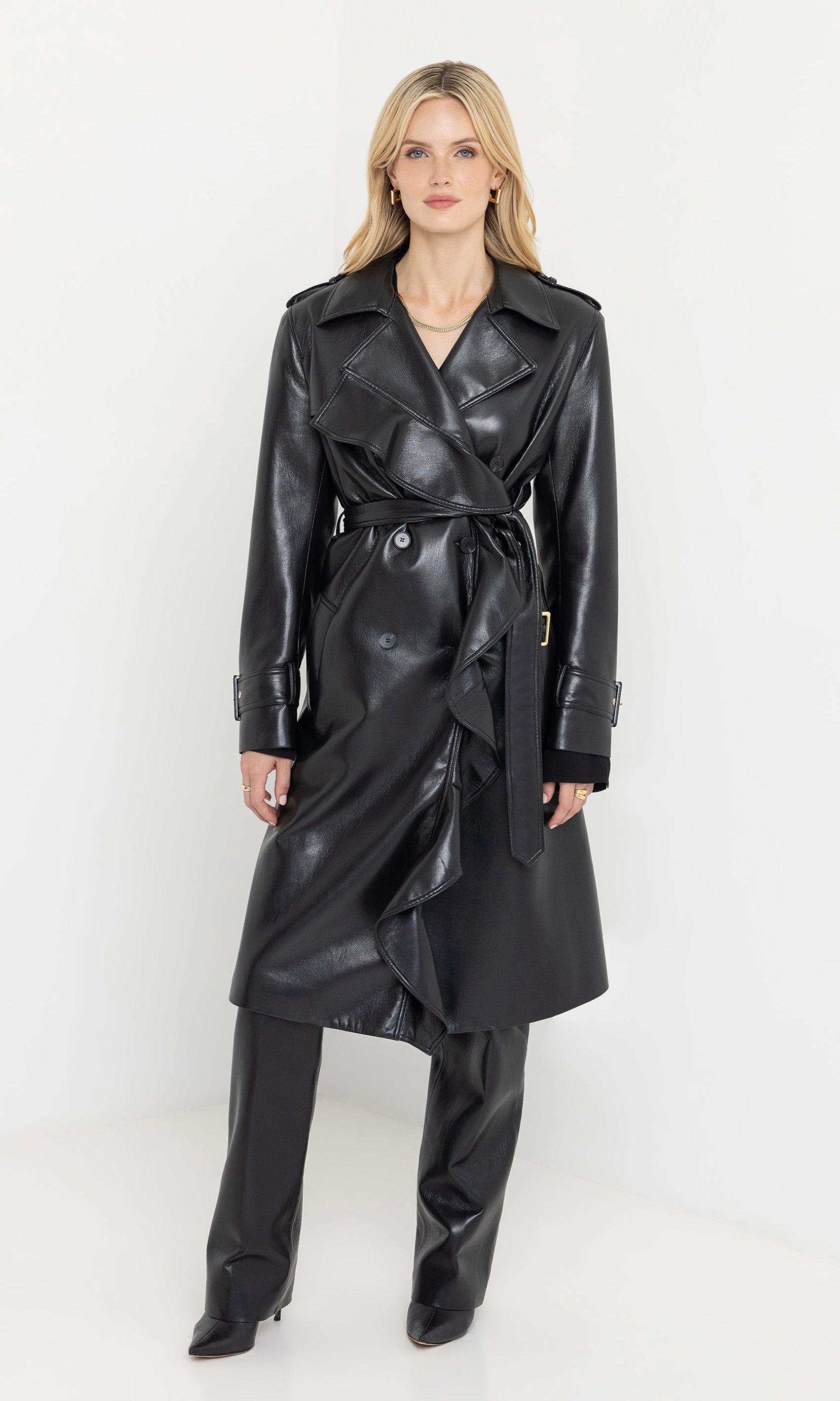 Front view of the model wearing the hearst vegan leather trench coat with belted waist.