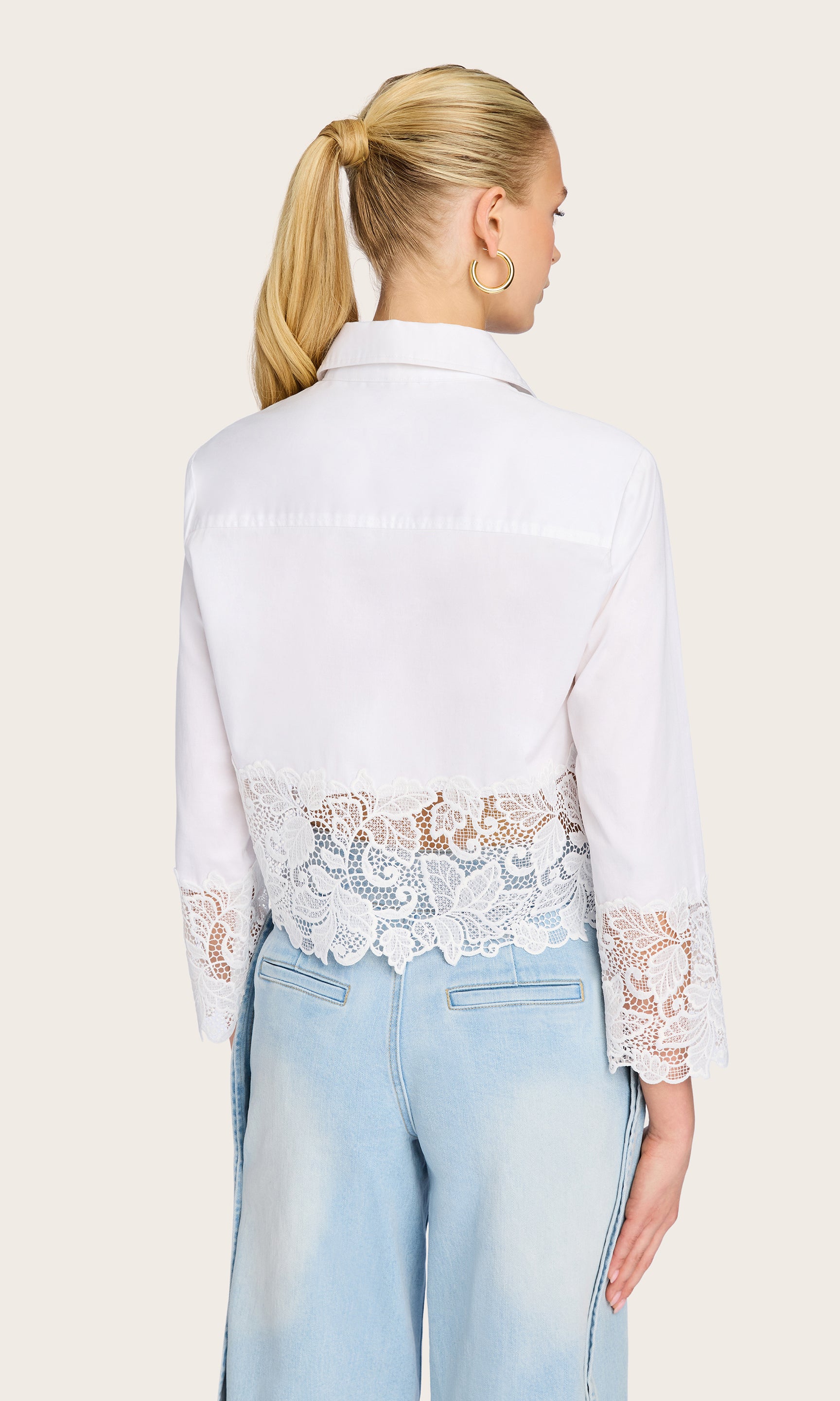 Rear view of the model wearing the Issa Lace Combo Shirt, showcasing the sheer lace detail and relaxed fit from behind.