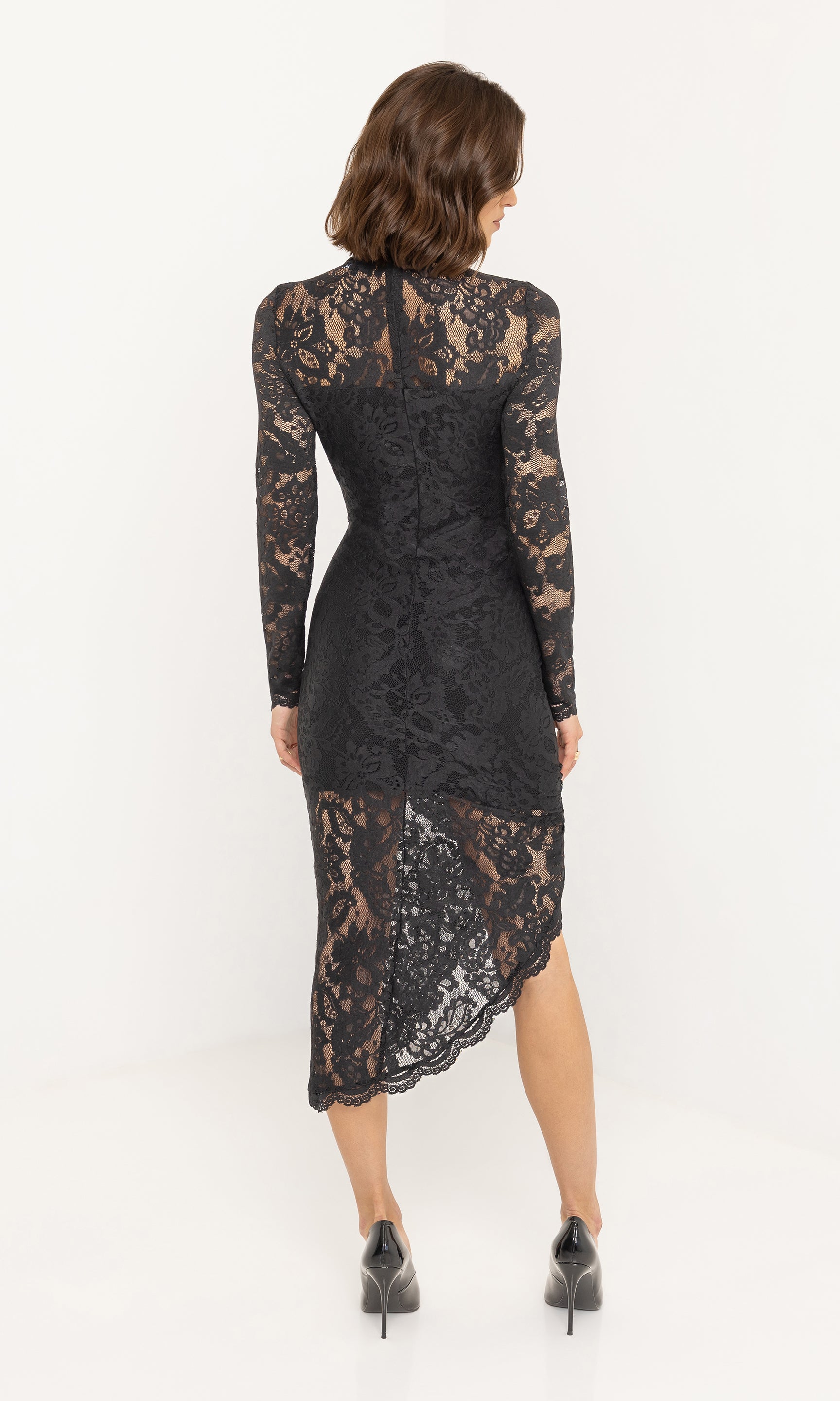 Rear view of the iria lace dress showing fitted lace silhouette.