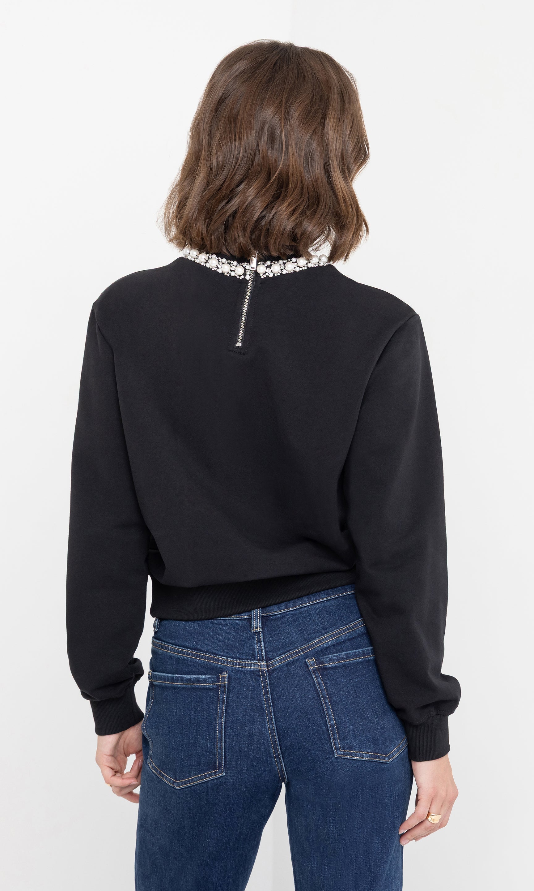 Three-quarter back view of the jill pearl/crystal embellished sweatshirt highlighting the fit.