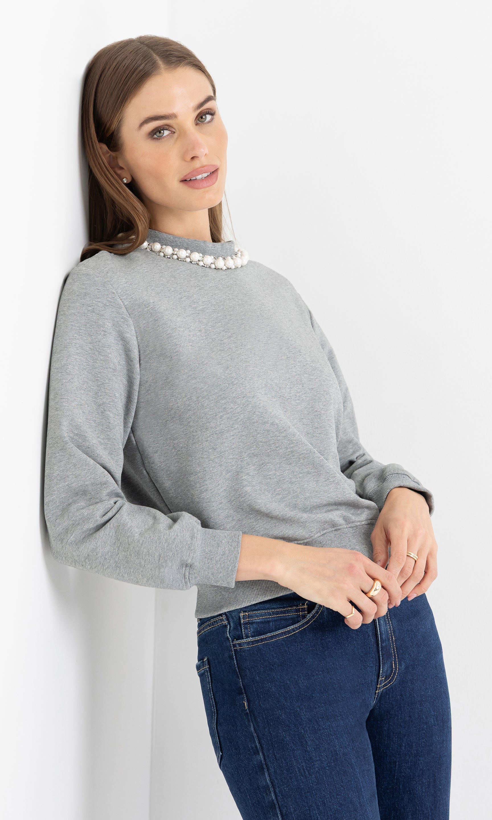 Three-quarter front view of the jill pearl/crystal embellished sweatshirt highlighting the pearl neckline.