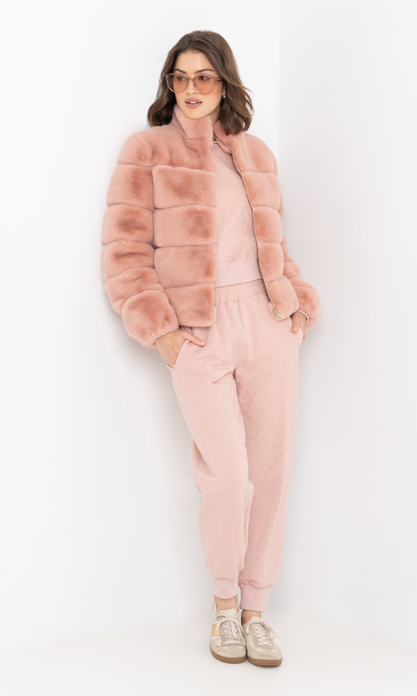 Full body front view of the brianna faux fur jacket paired with joggers.