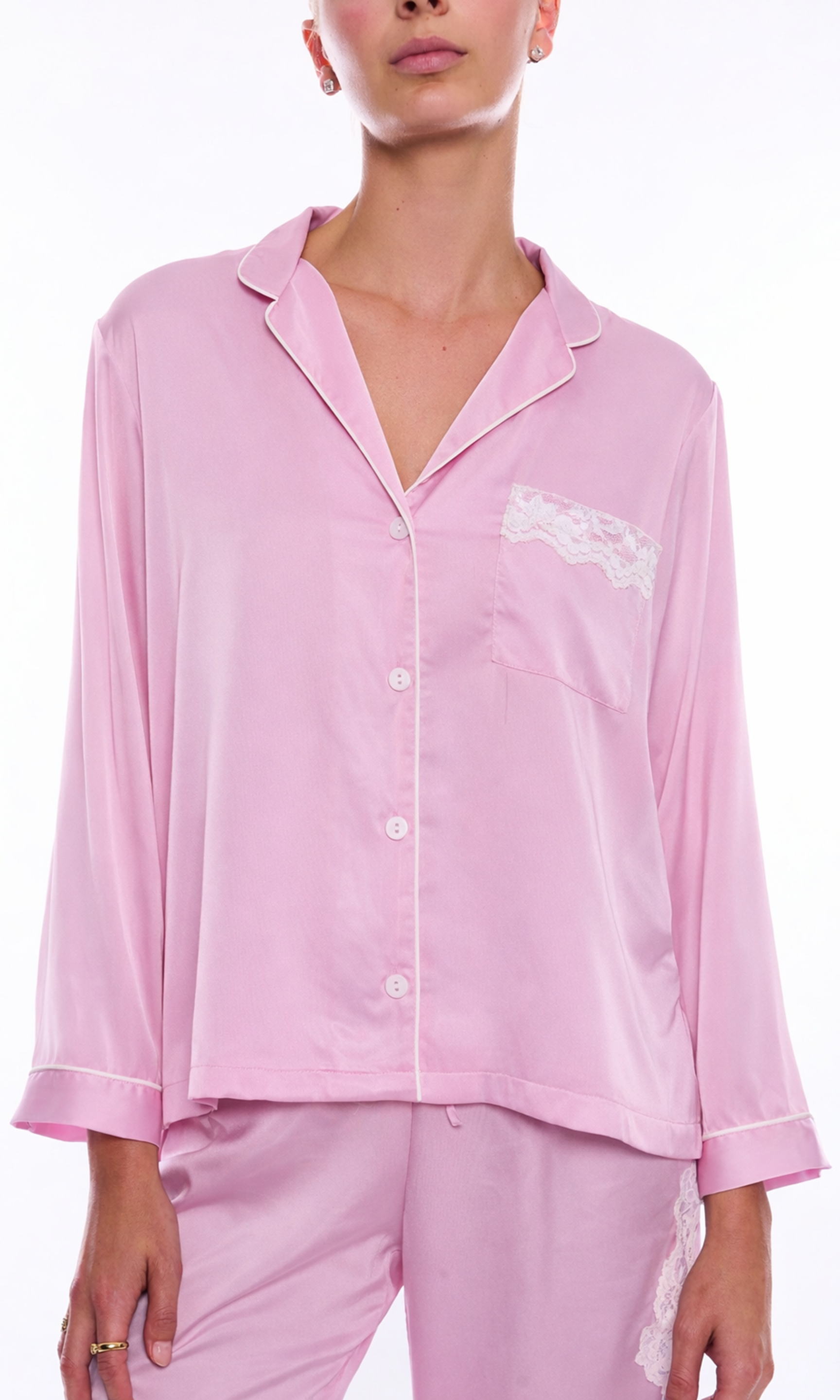 Pink pajama set with lace detail on a white background