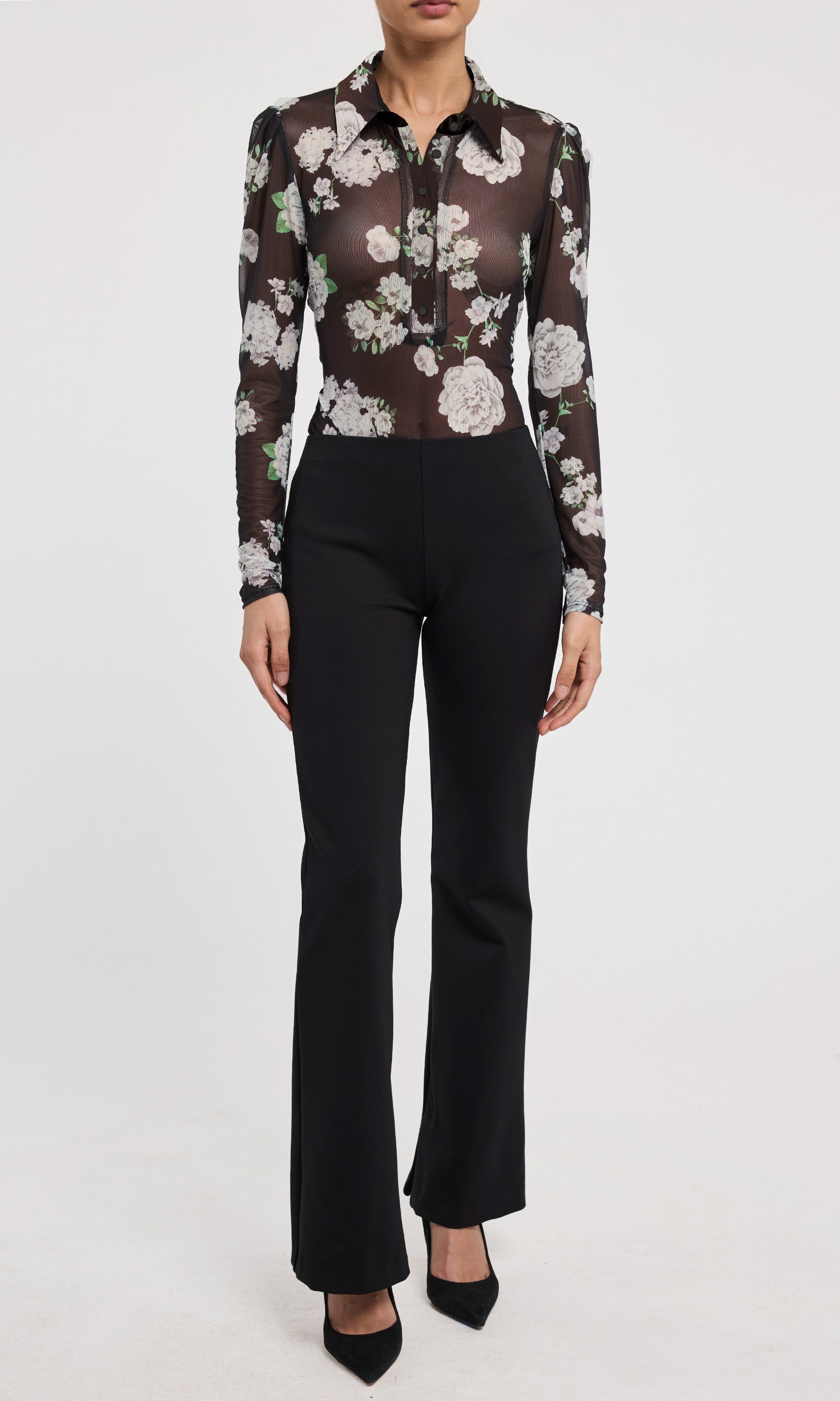 Sheer floral blouse with long sleeves and black pants on a white background