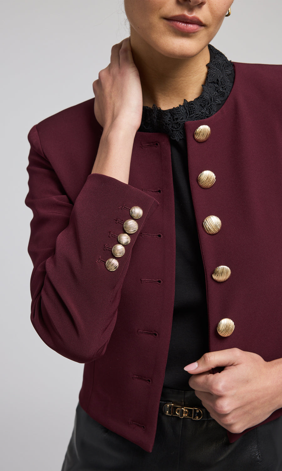 A striking malbec jacket with front buttons, highlighting a chic and fashionable outerwear choice.
