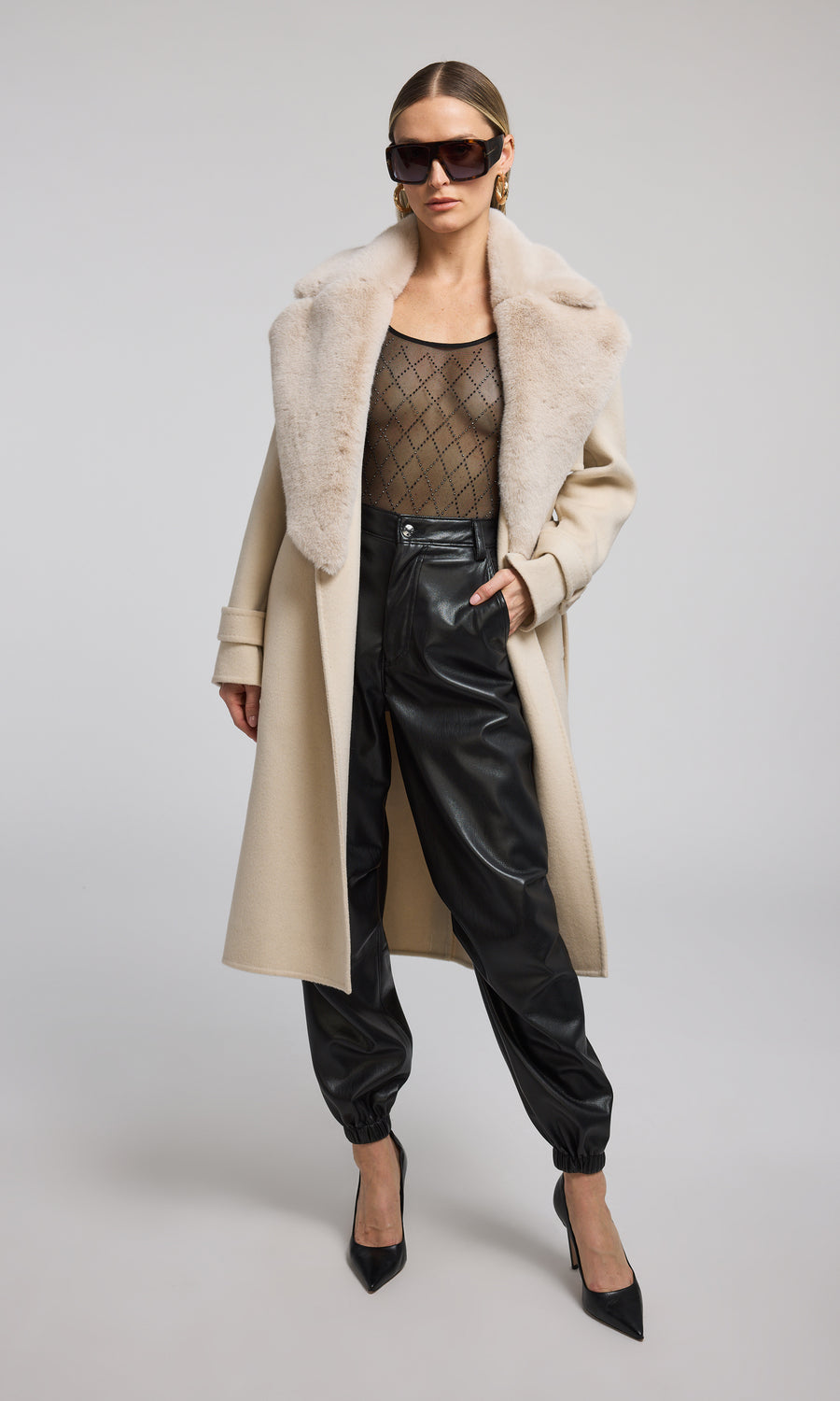 The image features a model in a chic beige coat adorned with a plush fur collar, highlighting a blend of comfort and style.