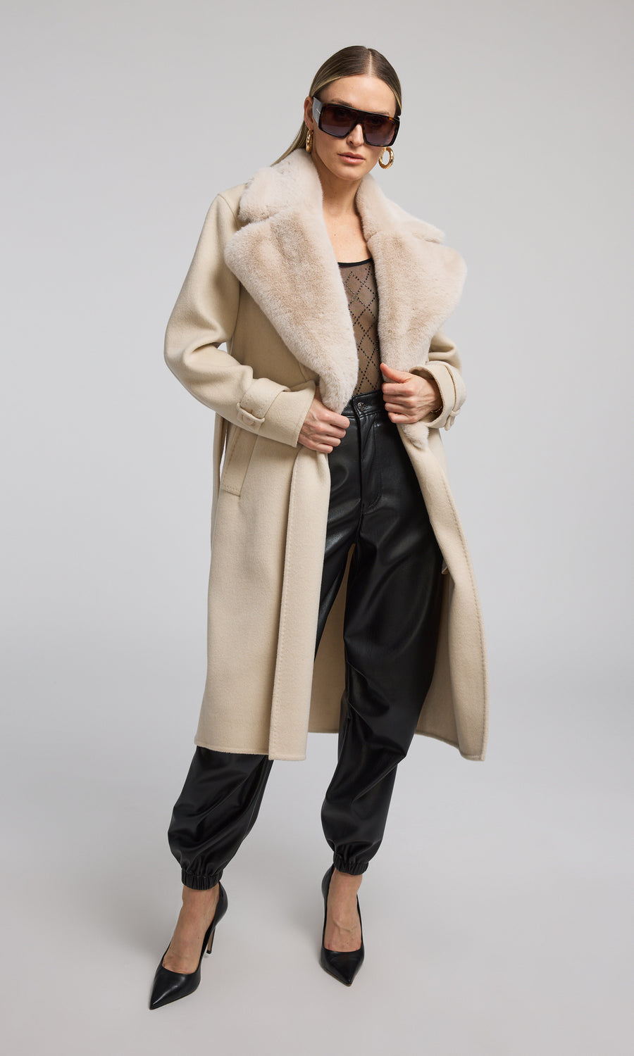 The image features a model in a chic beige coat adorned with a plush fur collar, highlighting a blend of comfort and style.