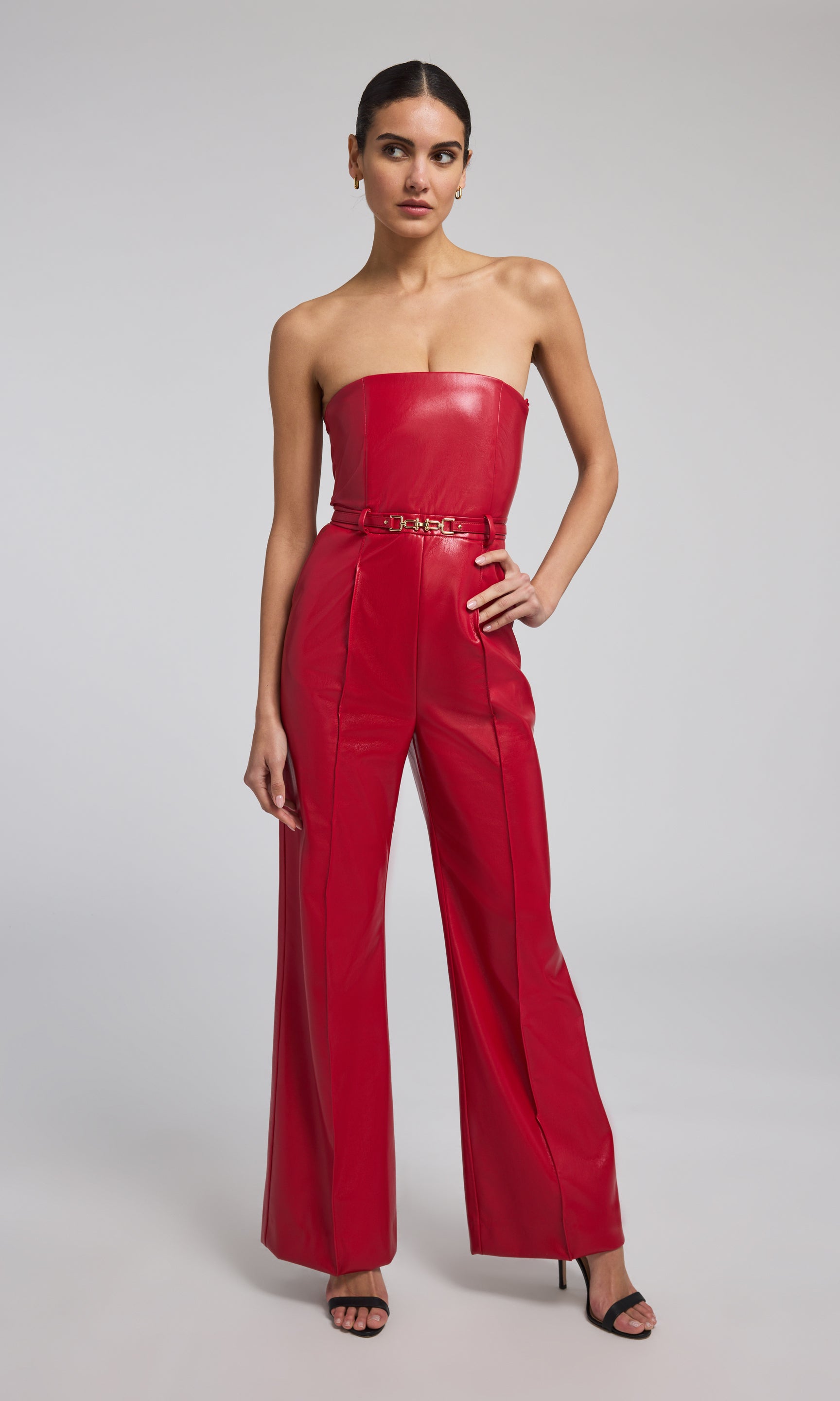 A ruby leather vegan jumpsuit, showcasing a vibrant red hue and sleek design, perfect for a stylish and eco-friendly look.