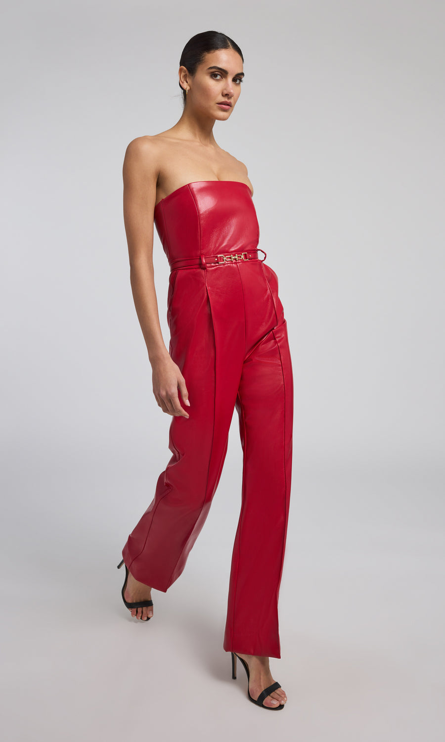 A ruby leather vegan jumpsuit, showcasing a vibrant red hue and sleek design, perfect for a stylish and eco-friendly look.