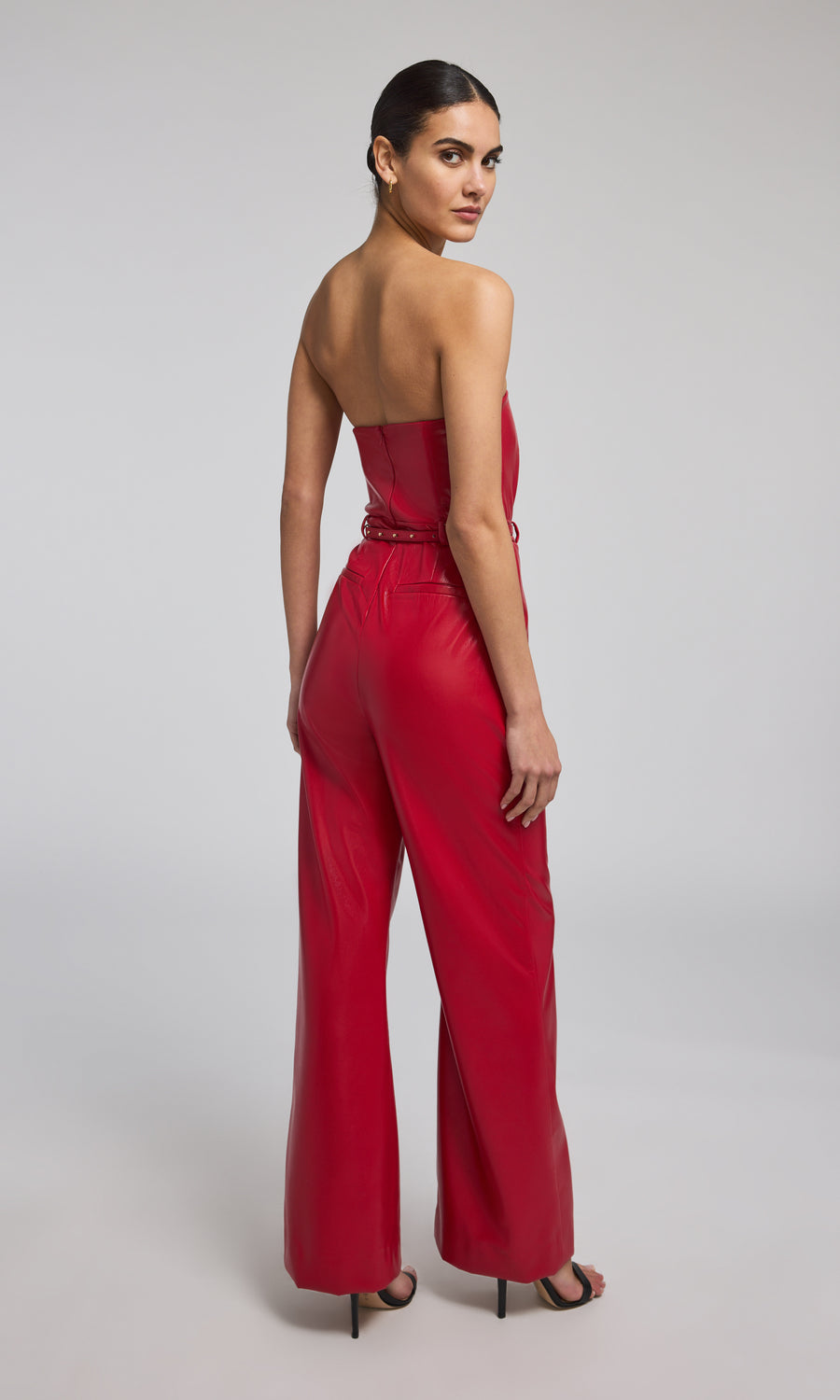 A ruby leather vegan jumpsuit, showcasing a vibrant red hue and sleek design, perfect for a stylish and eco-friendly look.