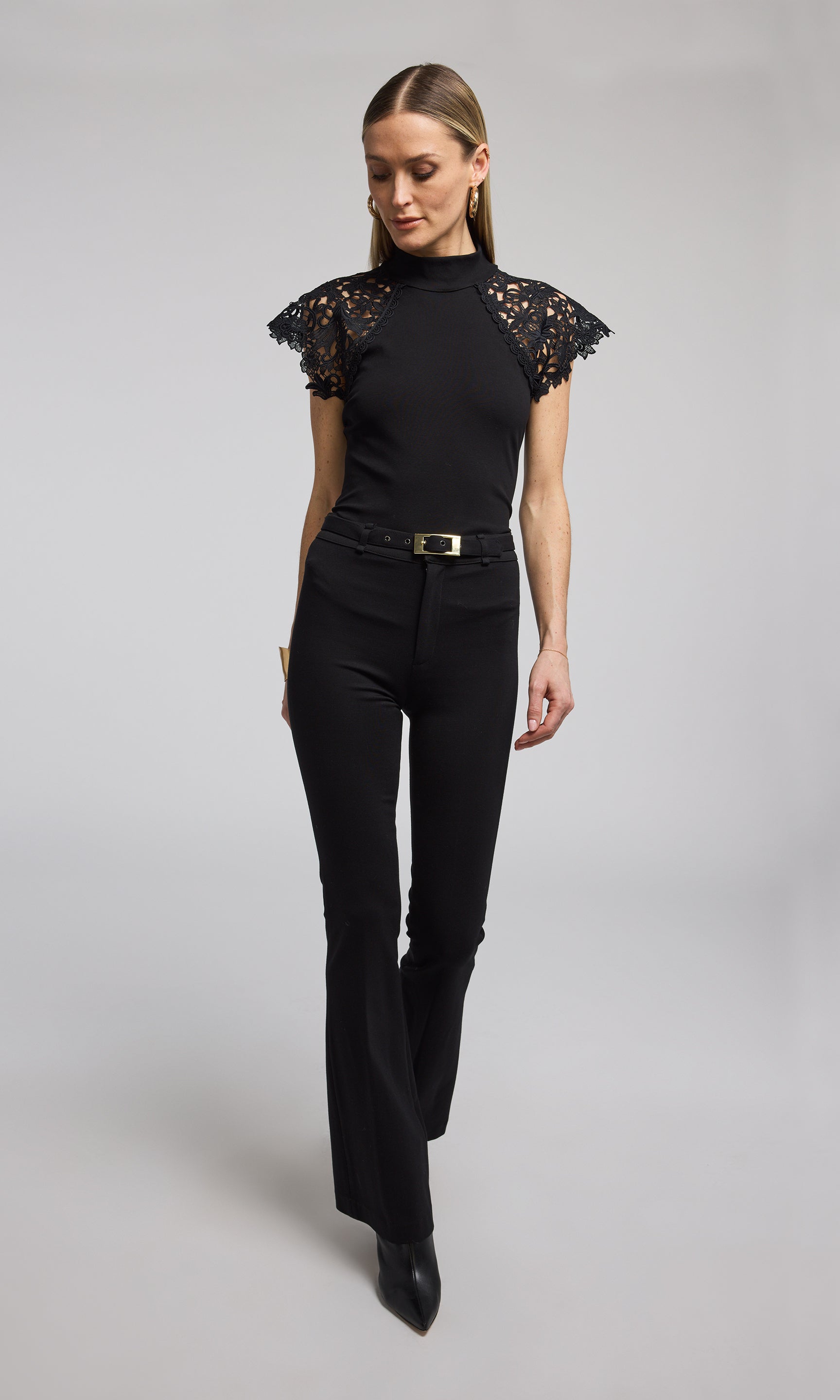 A black top featuring elegant lace sleeves, showcasing a sophisticated and stylish design. 