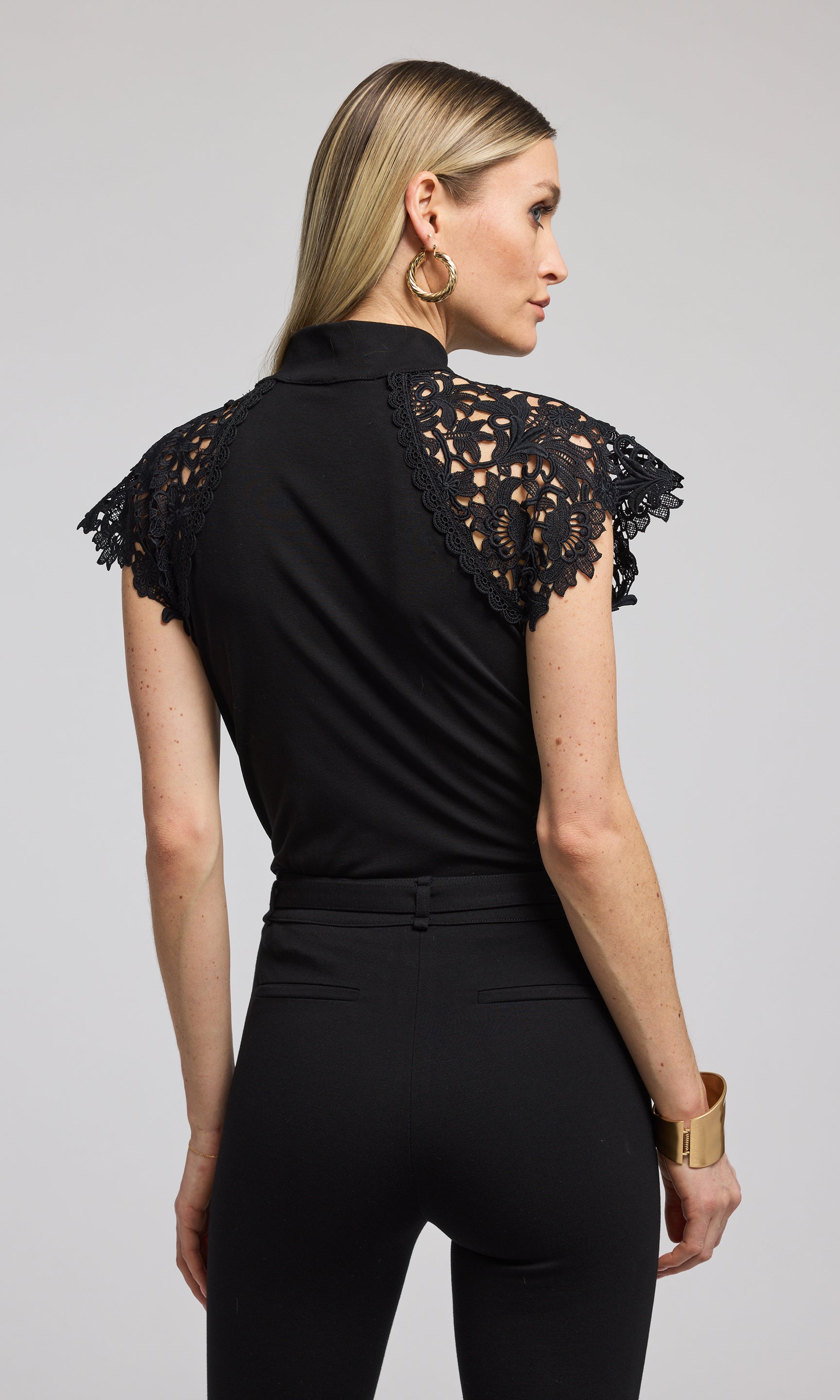 A black top featuring elegant lace sleeves, showcasing a sophisticated and stylish design. 