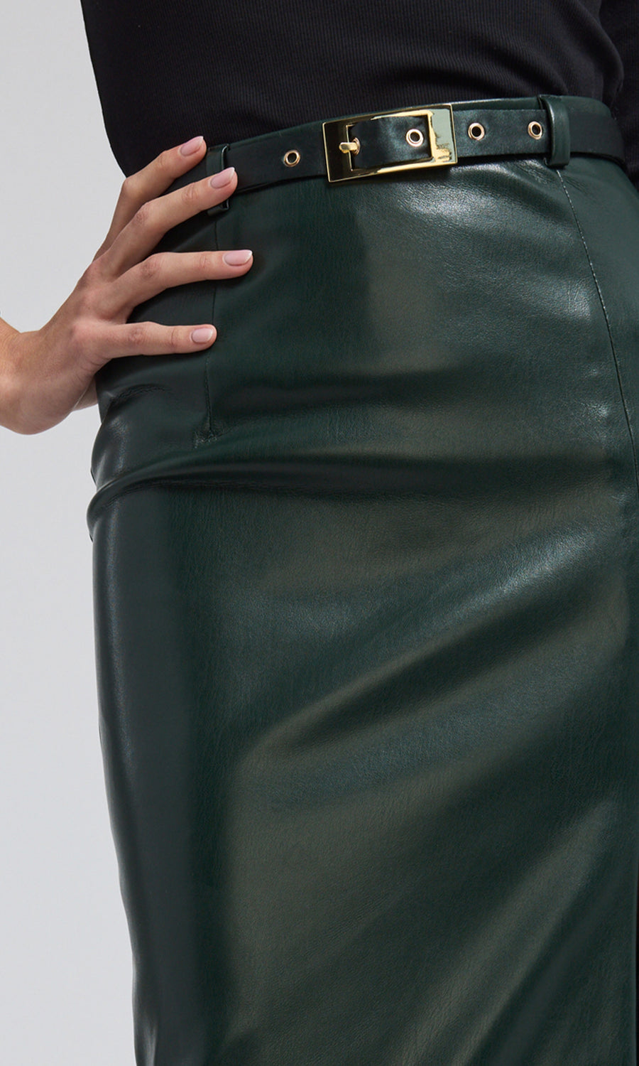 A chic vegan leather midi skirt, combining sophistication and a touch of sensuality in its design.