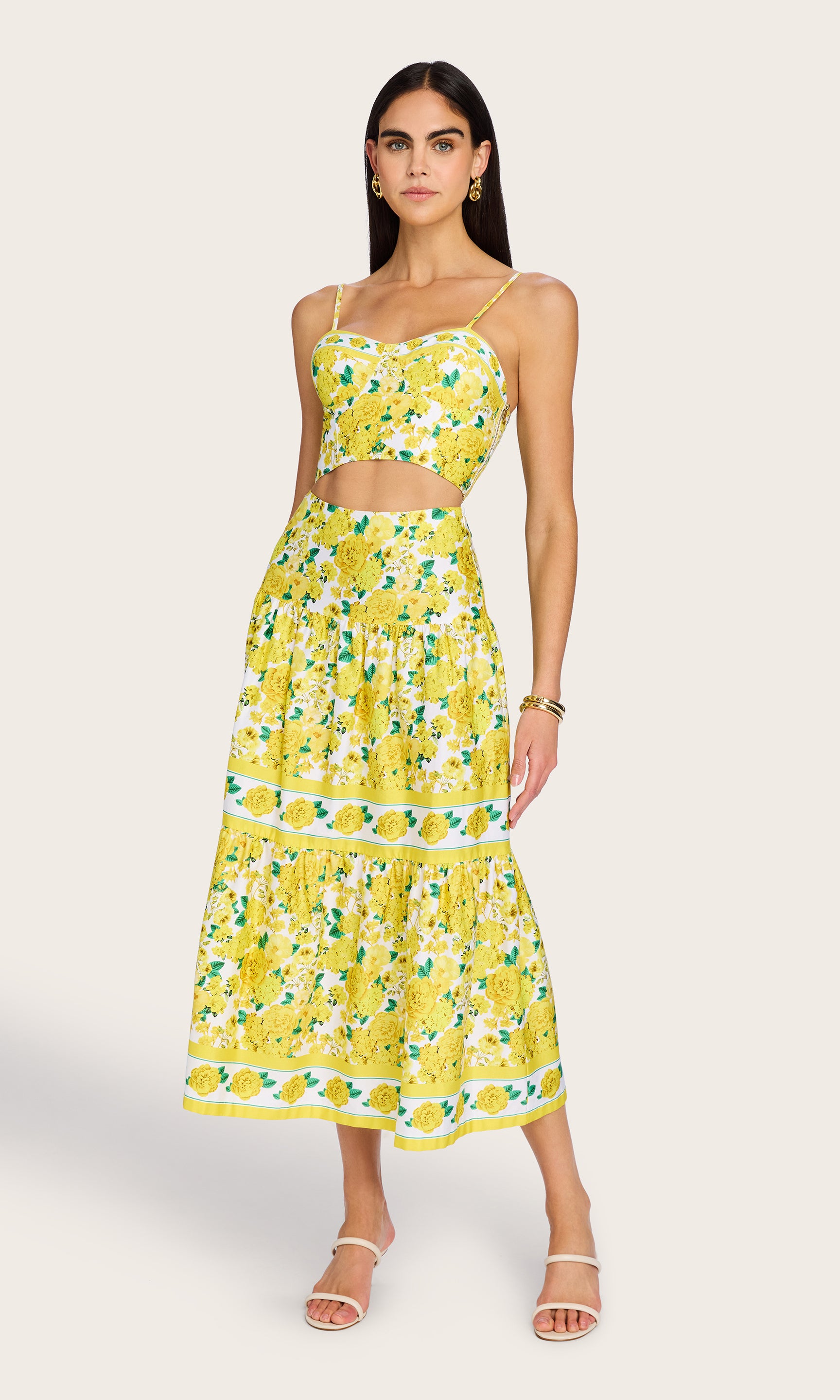 Full-body front view of the model in the Mondo Floral Poplin Skirt, styled with heels to emphasize its maxi length and flared silhouette.