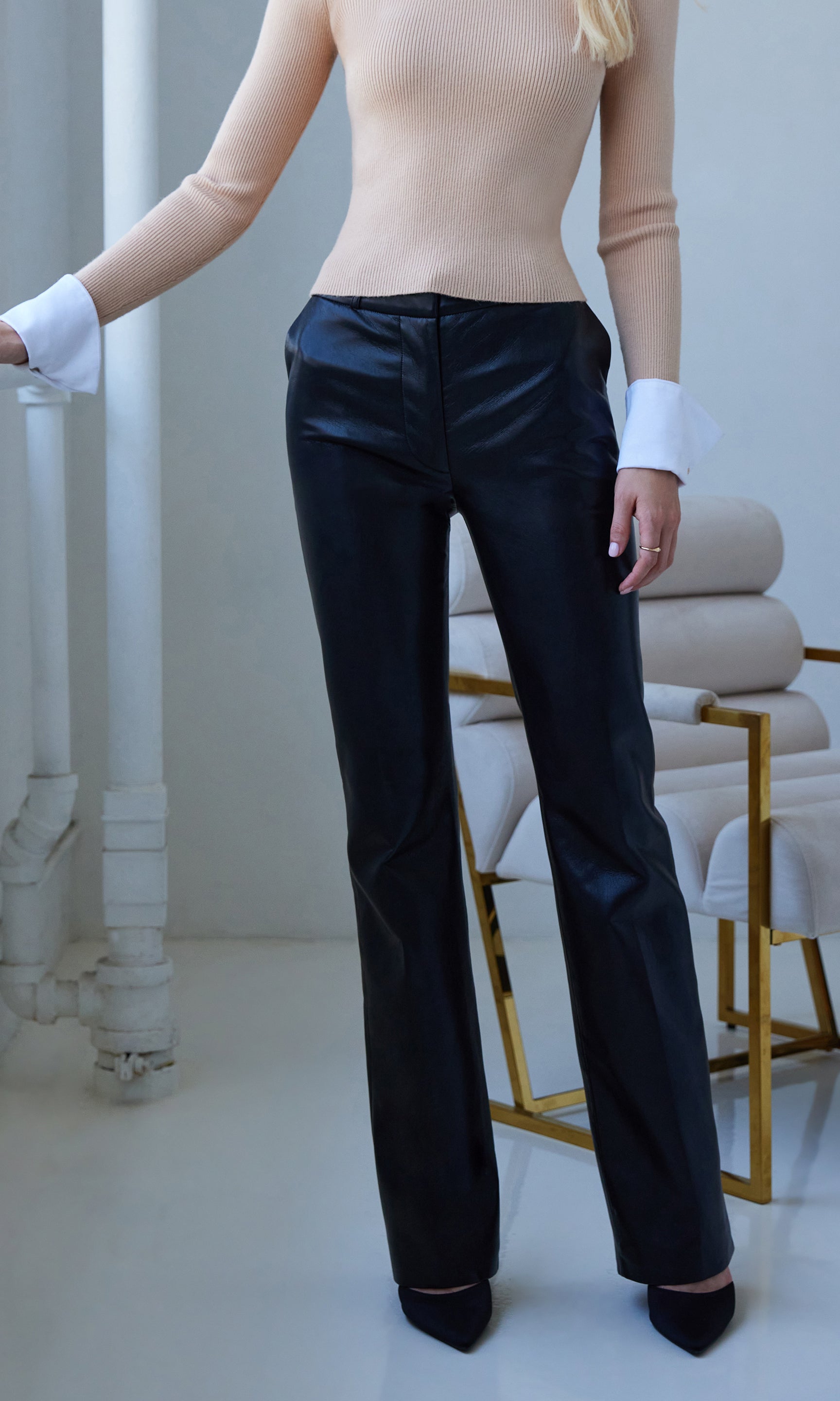 Close view highlighting the sleek fit and straight-leg silhouette of the vegan leather pants.