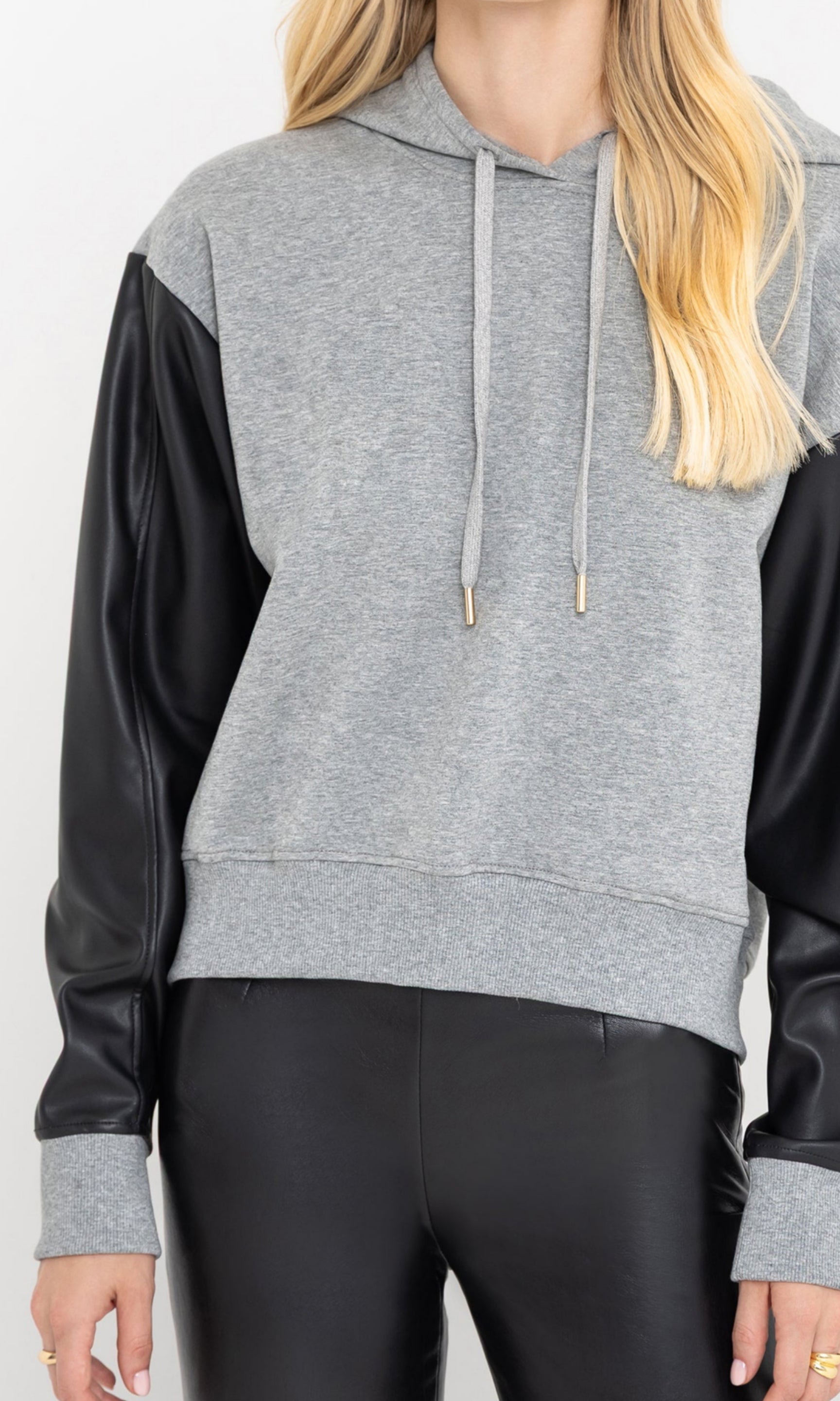 Three-quarter front view of the lisbet vegan leather combo hoodie.