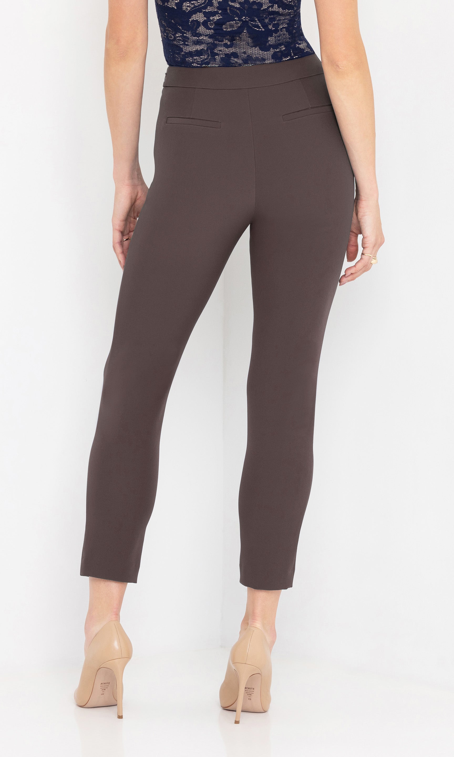 Back view shot of brown pants worn by a person on a white background
