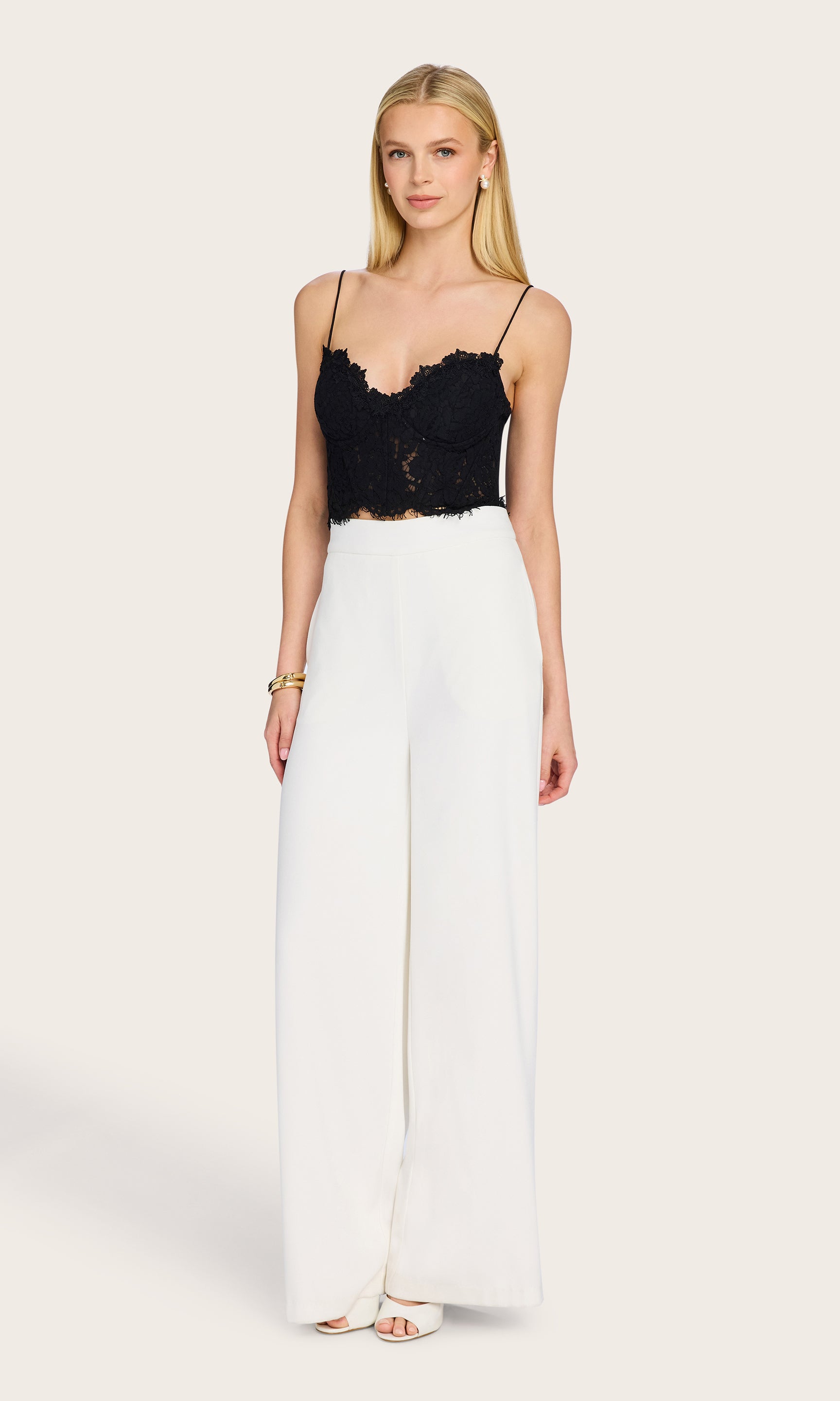 Full body view of the Miami Lace Bustier styled with wide-leg trousers and heels for a polished look.
