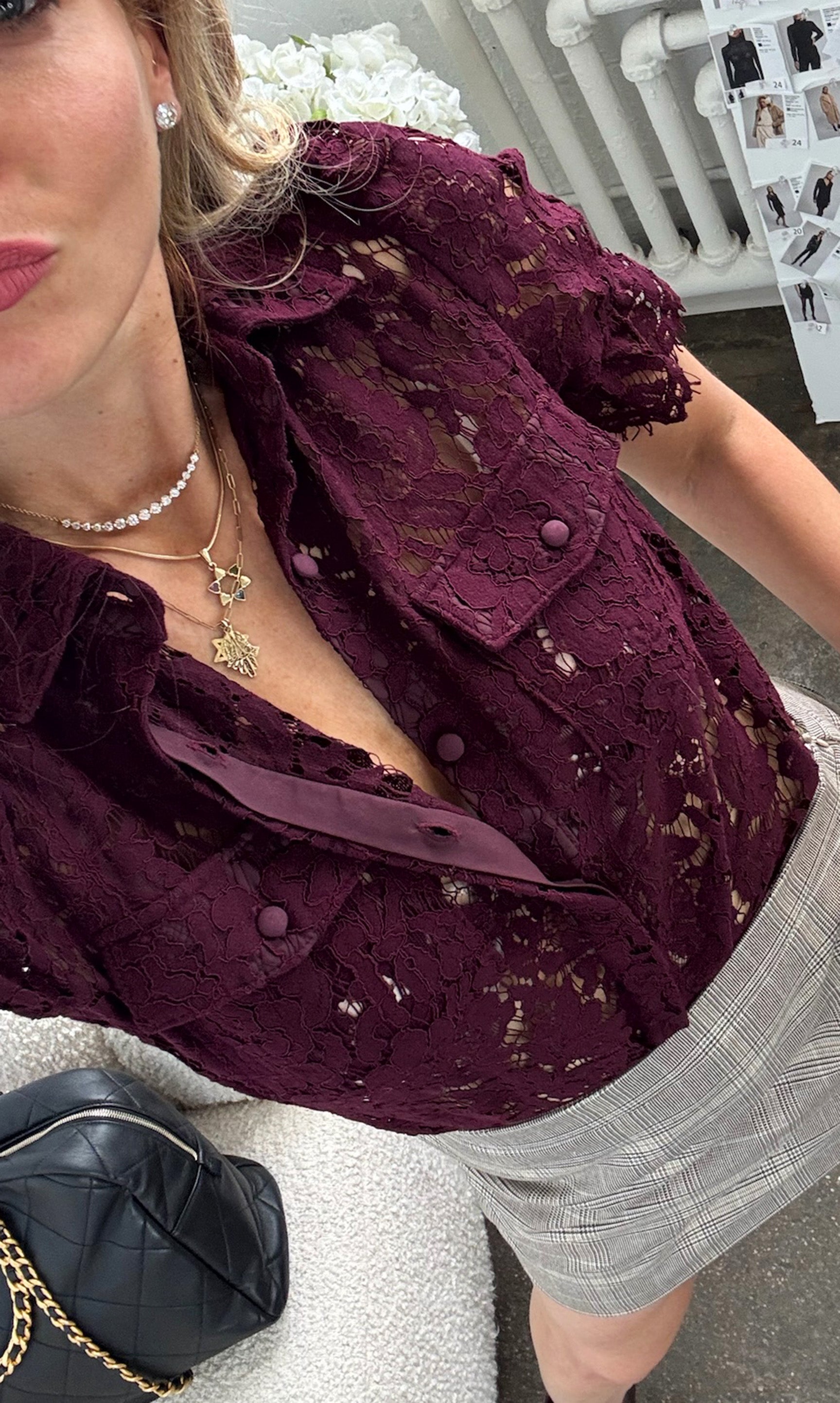 Our founder Roni wearing a burgundy lace top with a blurred background