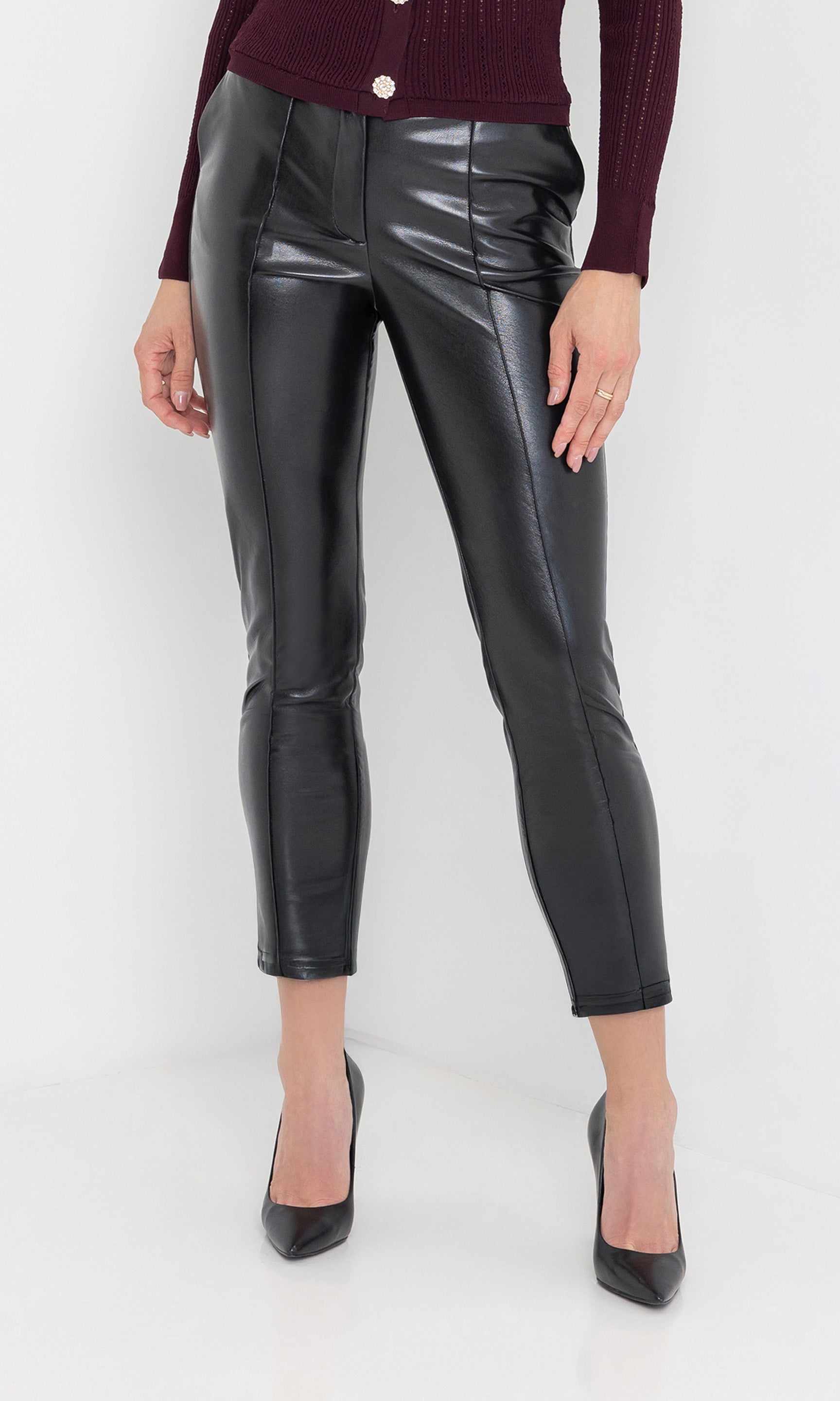 Front view of the tula vegan leather pants showing the sleek ankle length.