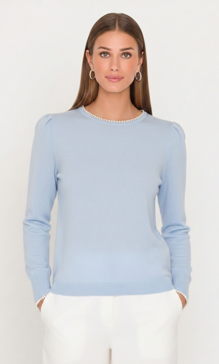 Woman wearing a light blue sweater against a white background