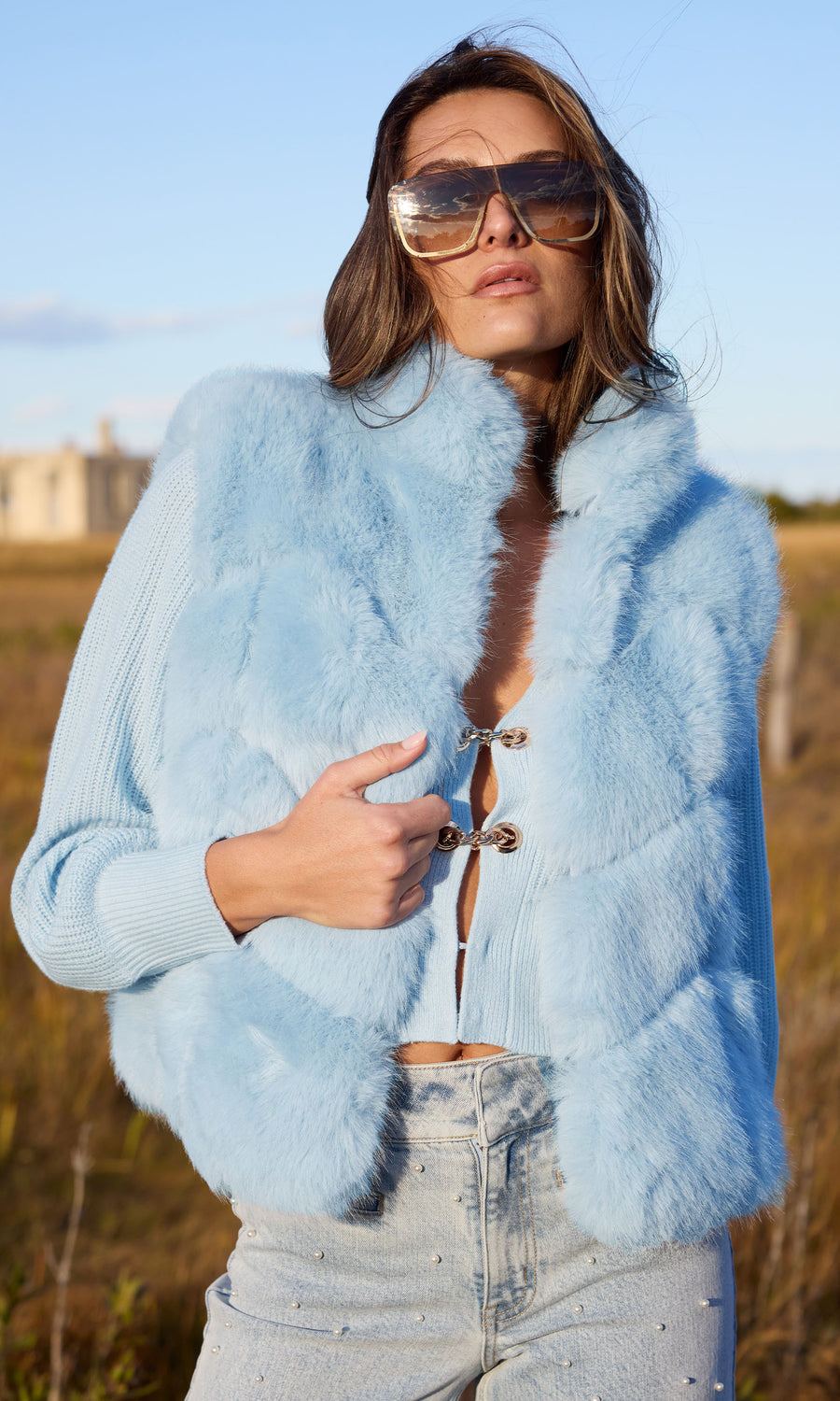 Elegant blue faux fur vest, crafted from high-quality materials, offering a chic and sophisticated look for various occasions.