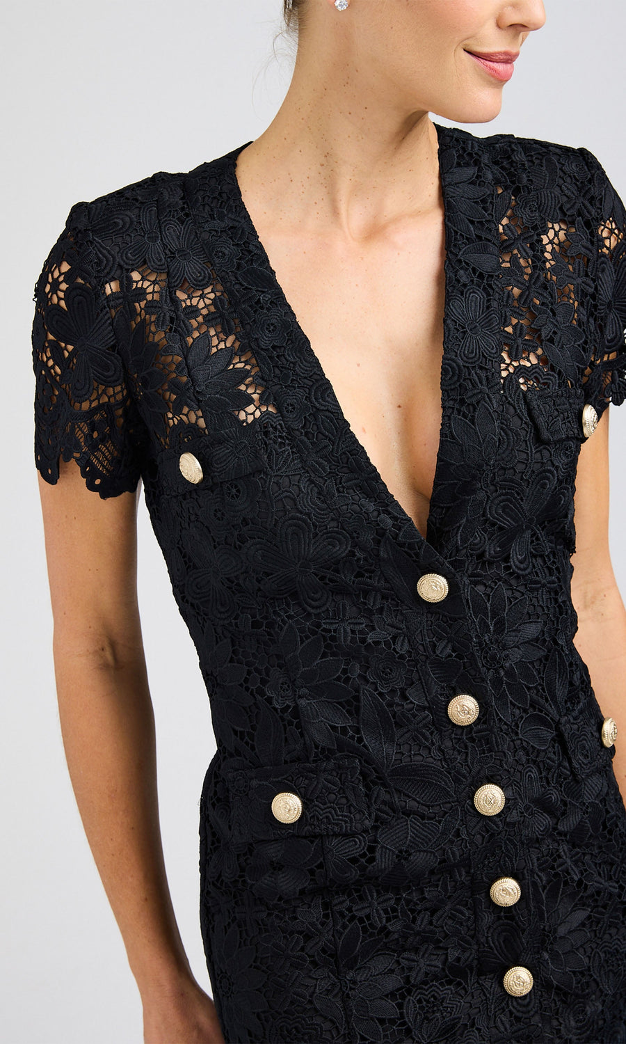 Close-up side angle highlighting the intricate lace design and deep V-neckline of the black lace dress.