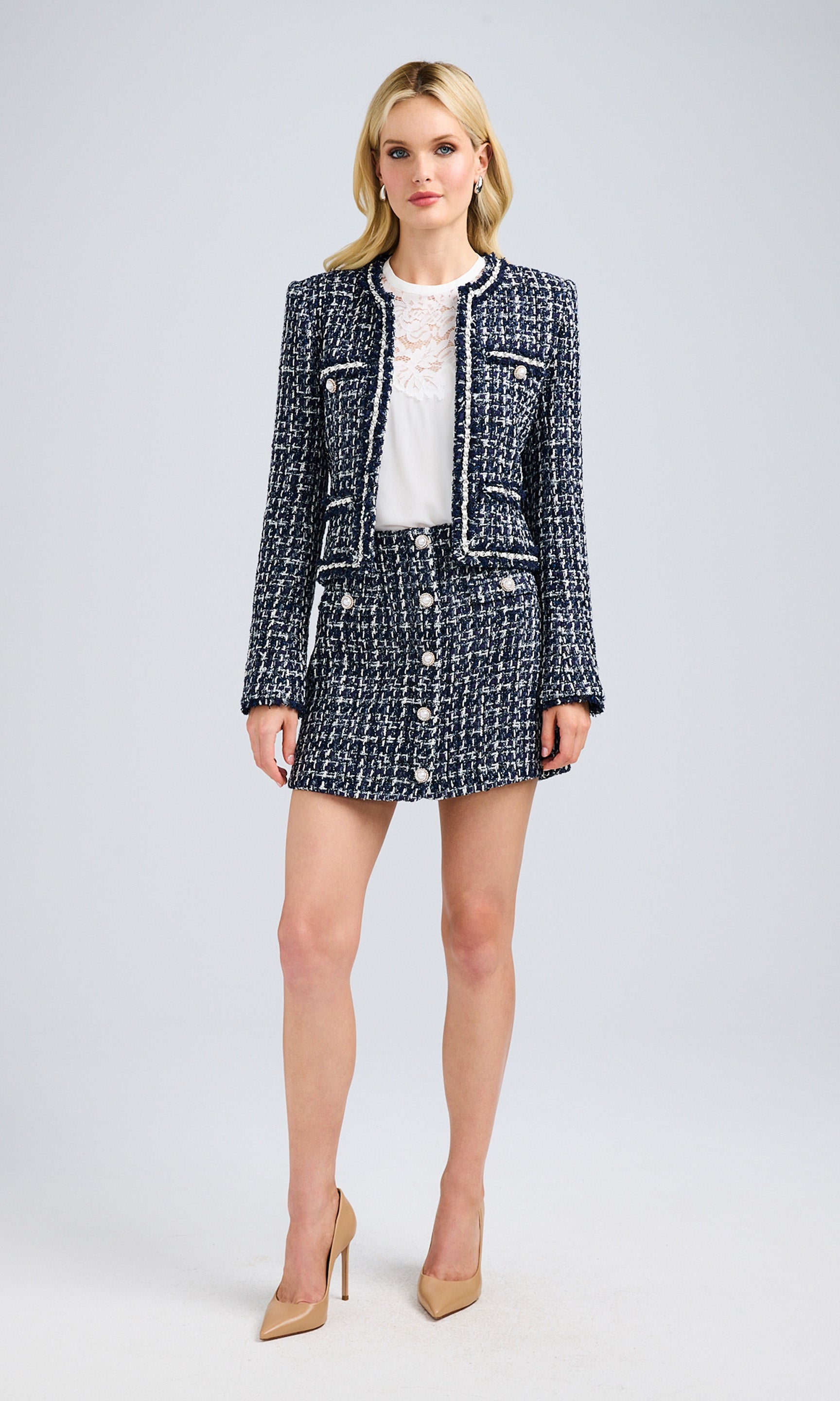 Full-body view of the blazer styled with a matching skirt, emphasizing a polished outfit.