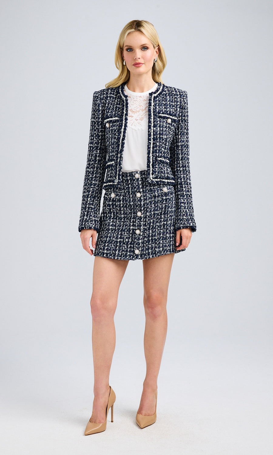 Full-body view of the blazer styled with a matching skirt, emphasizing a polished outfit.