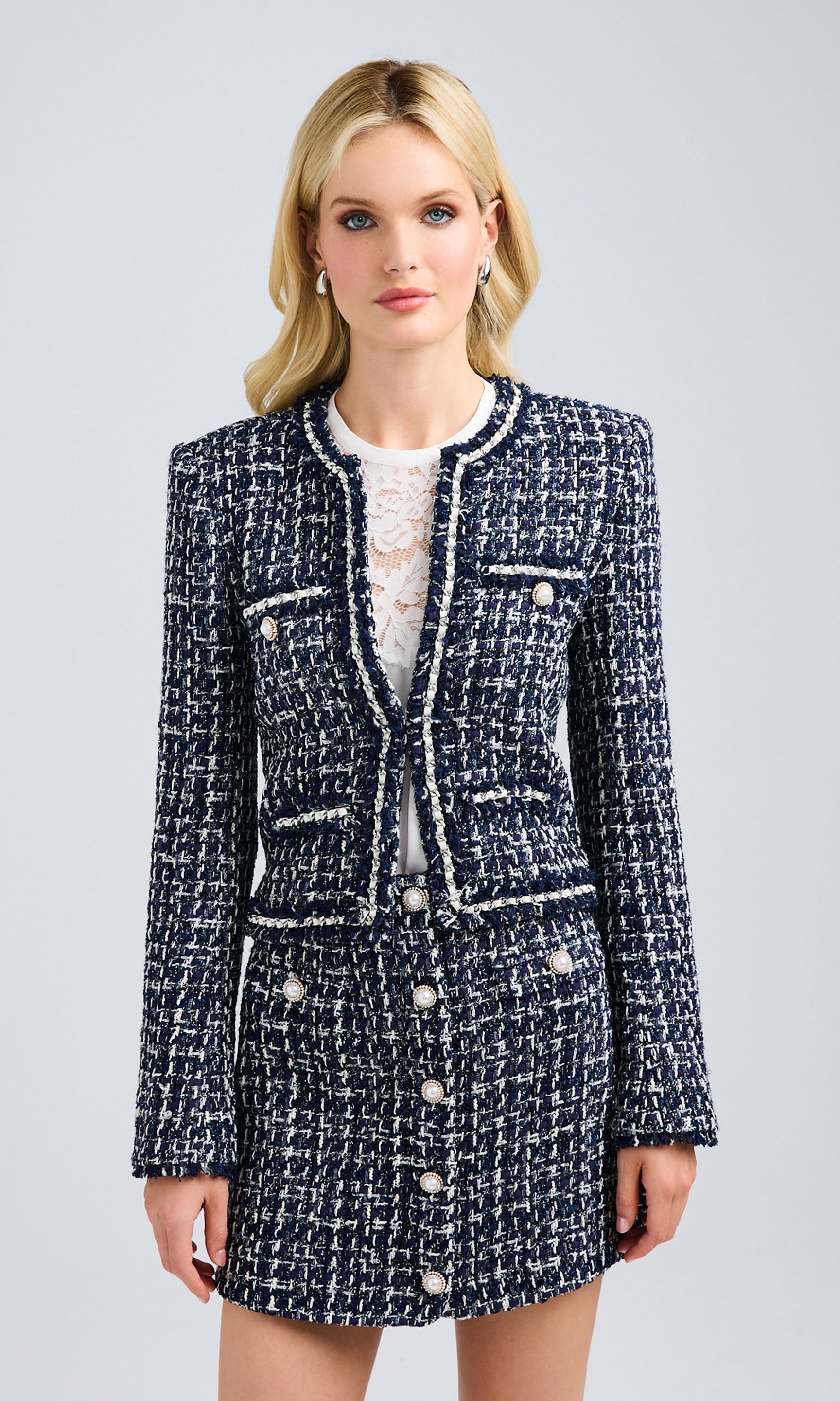 Front view of the tweed blazer paired with a matching skirt, showcasing its tailored fit and structured design.