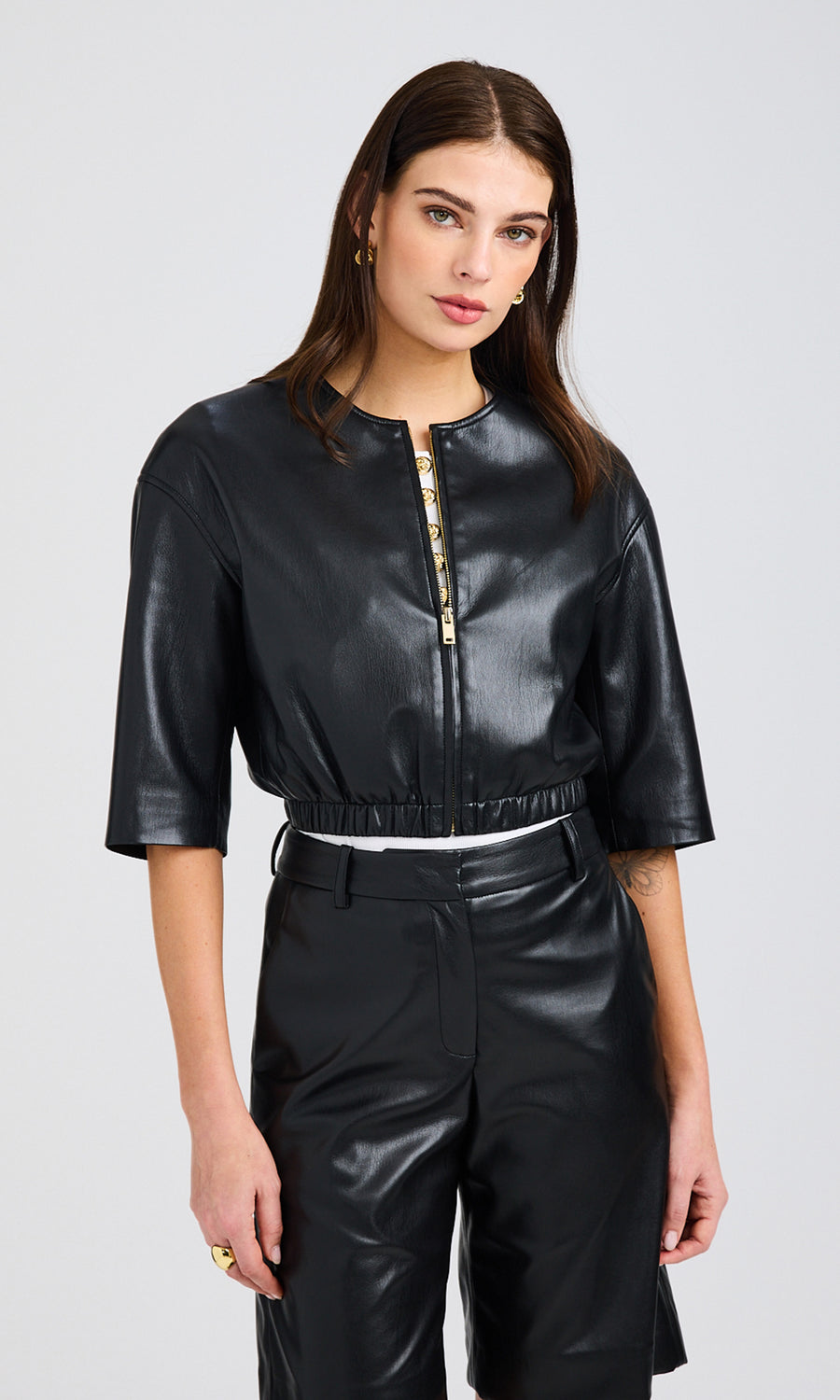 Front-facing view of the model wearing the Brando Vegan Leather Bomber in black, highlighting its zippered front and regular fit