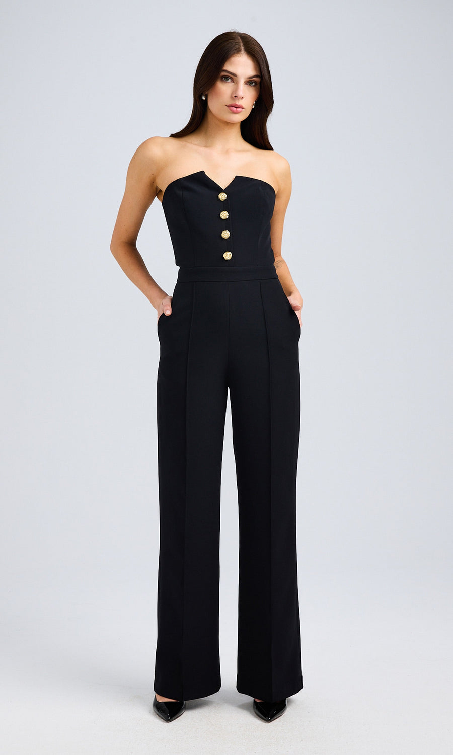 Front-facing full-body view of the model in the black jumpsuit, emphasizing the chic and polished look.