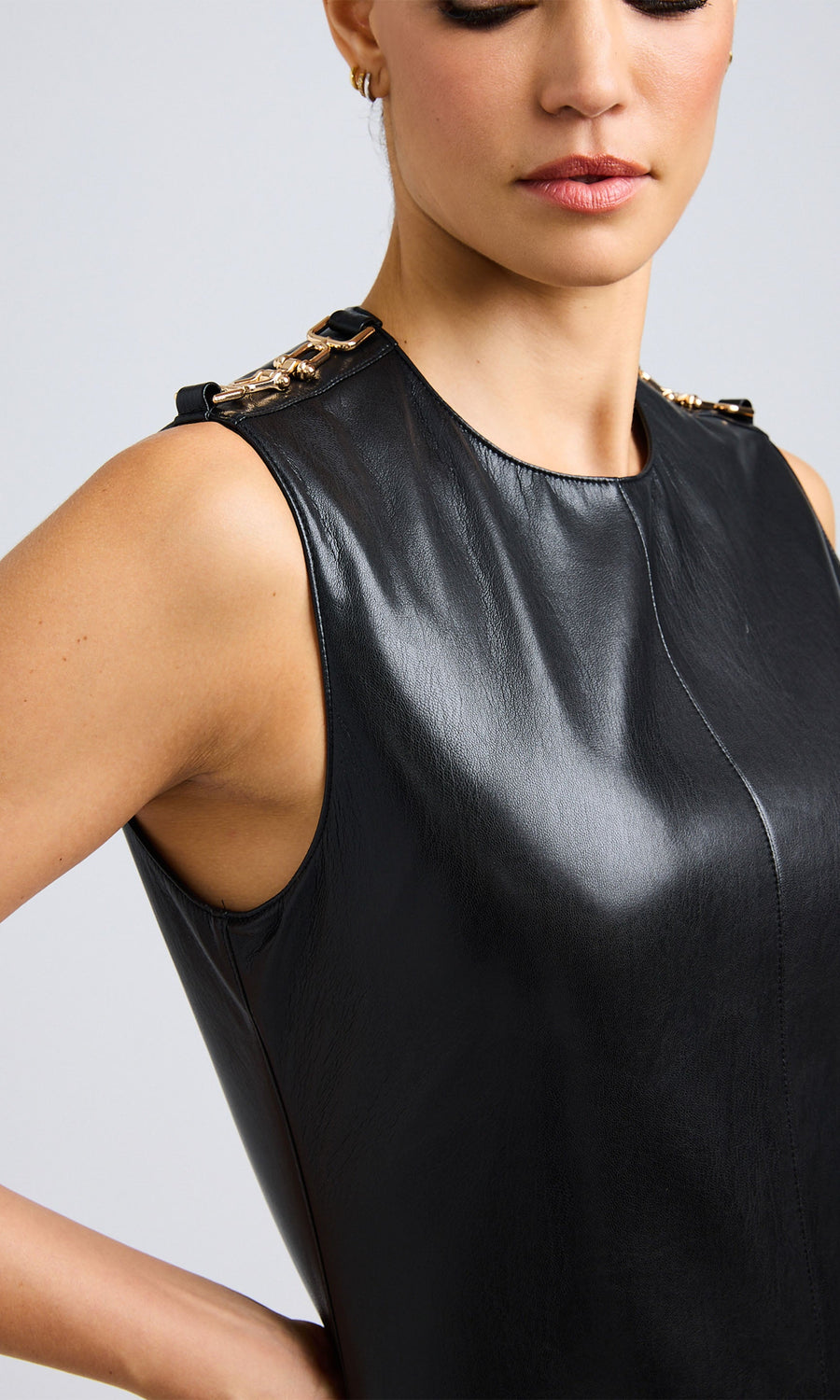 Close-up view highlighting the sleek texture and high neckline of the black vegan leather dress.