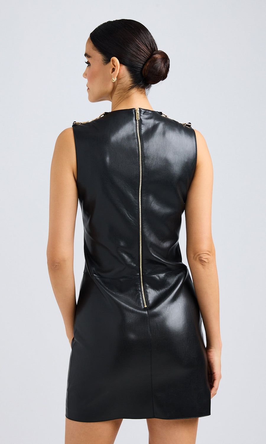 Rear view of the black vegan leather dress, emphasizing the smooth back design and tailored fit.