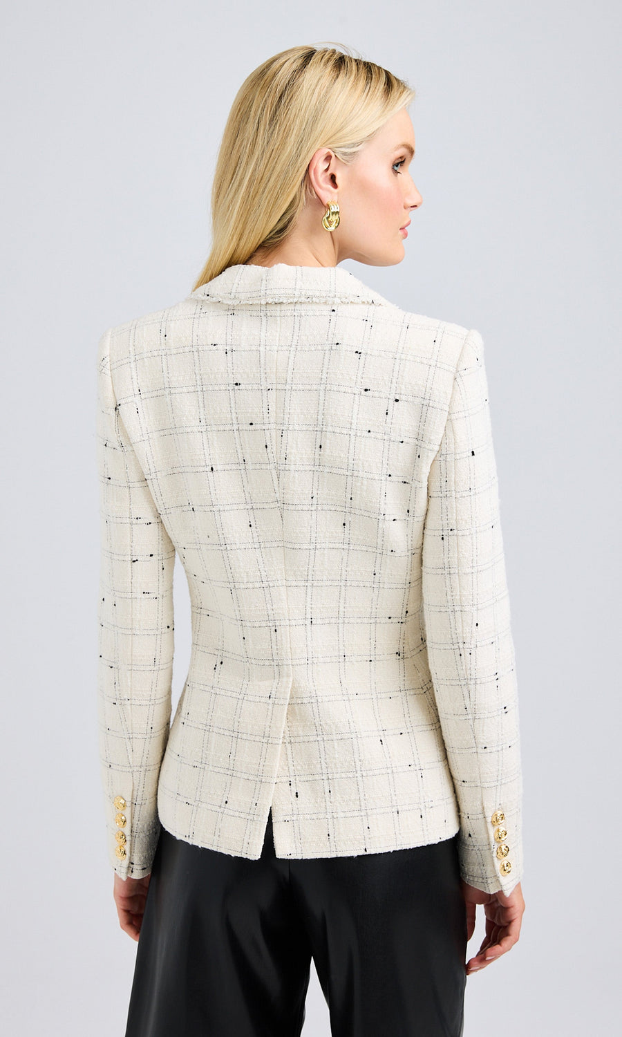 Back view of the white tweed jacket, showcasing the clean lines and classic cut.