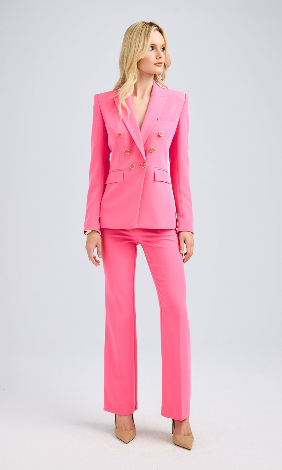 Full-body shot presenting the matching blazer and pants ensemble styled with nude heels for a sleek, polished look