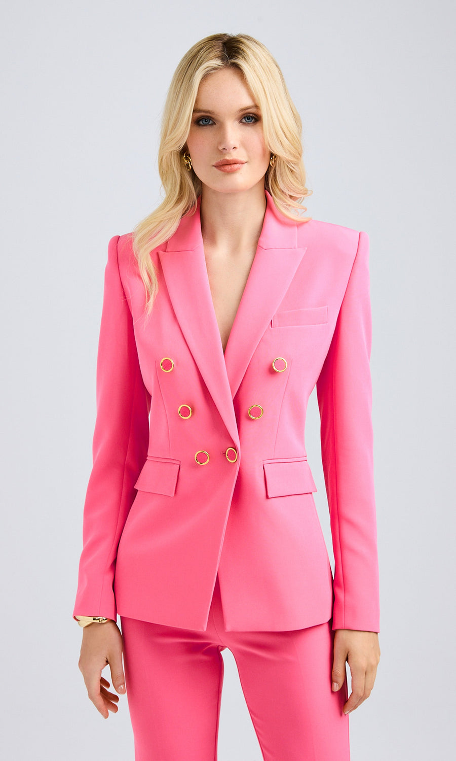 Front-facing view showcasing the structured fit and tailored silhouette of the double-breasted blazer with gold buttons