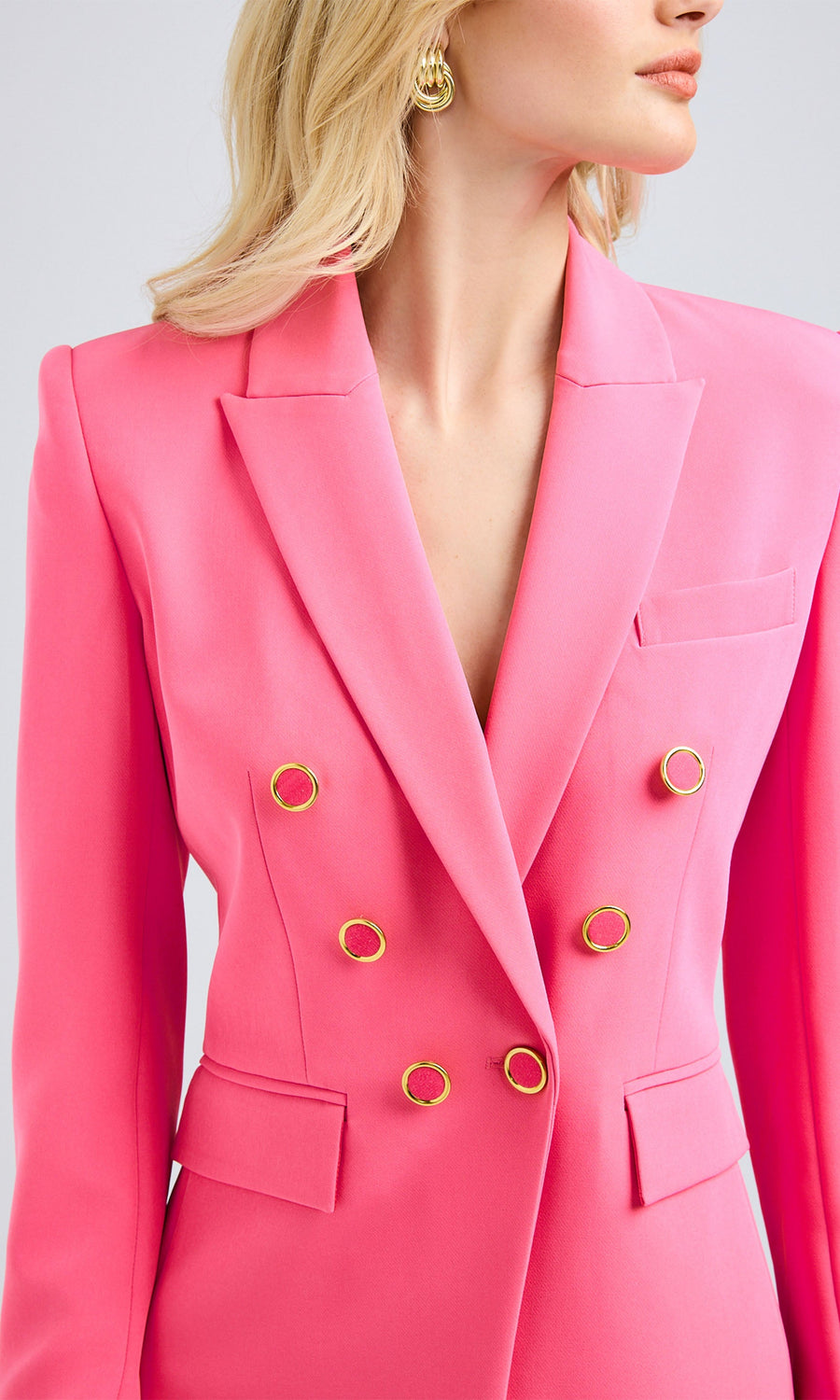 Close-up view highlighting the sharp lapels and pocket detailing, adding dimension to the structured design